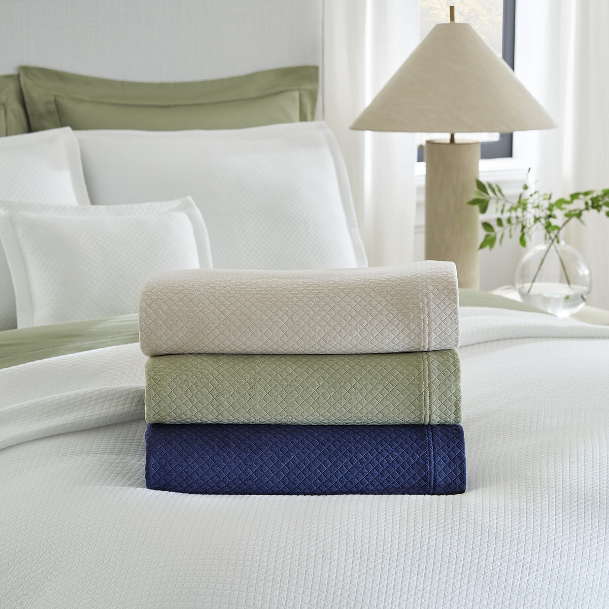 Stack of Sferra Rombo Coverlets with Different Color Options