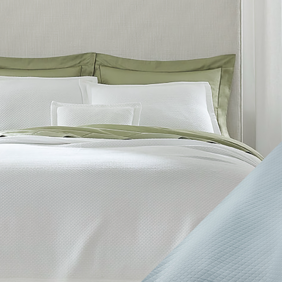 A neatly made bed with a Rombo coverlet, Sferra white Rombo bedding, and poolside swatch. 