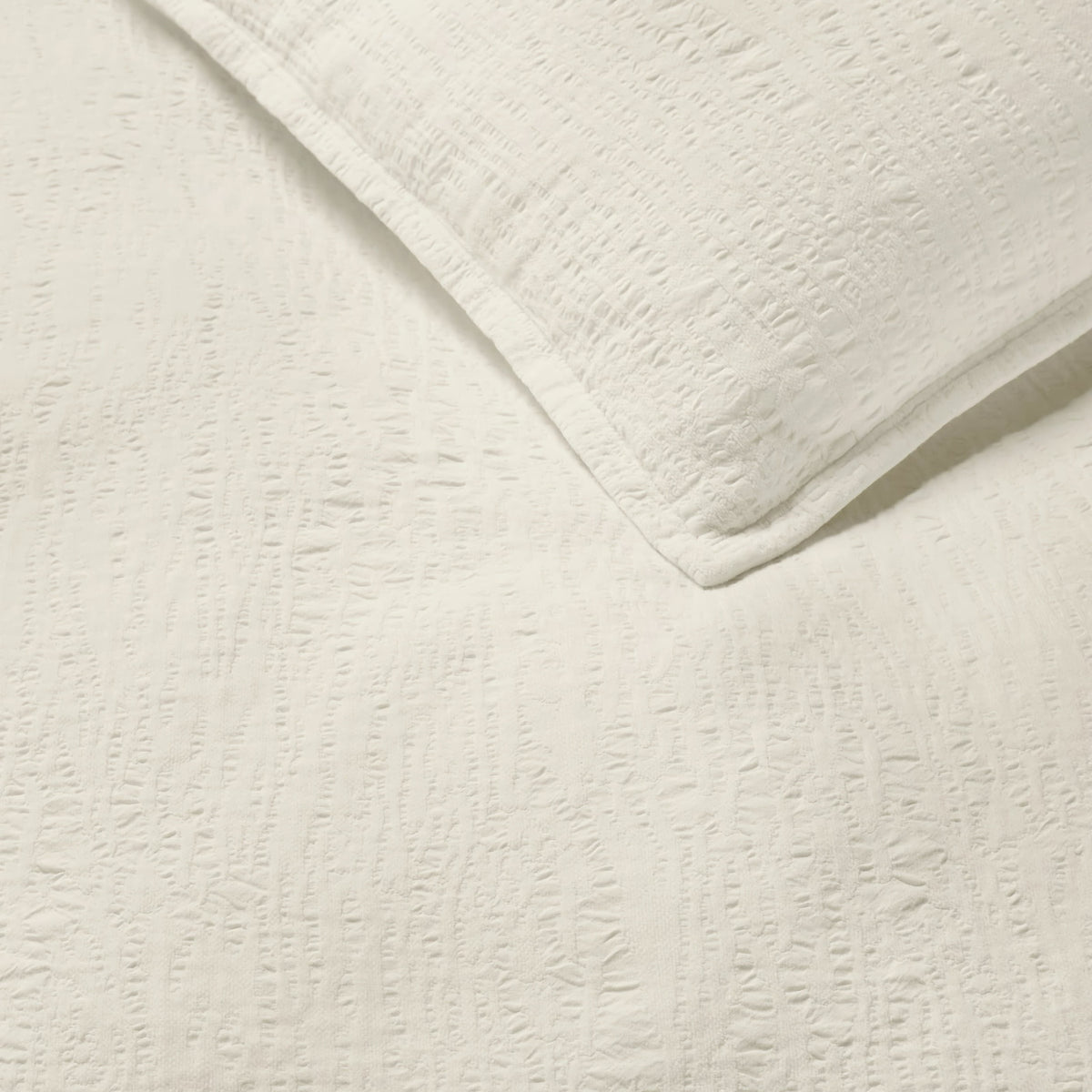 Detailed view of Sferra Sabino Coverlet and Shams in Oyster color