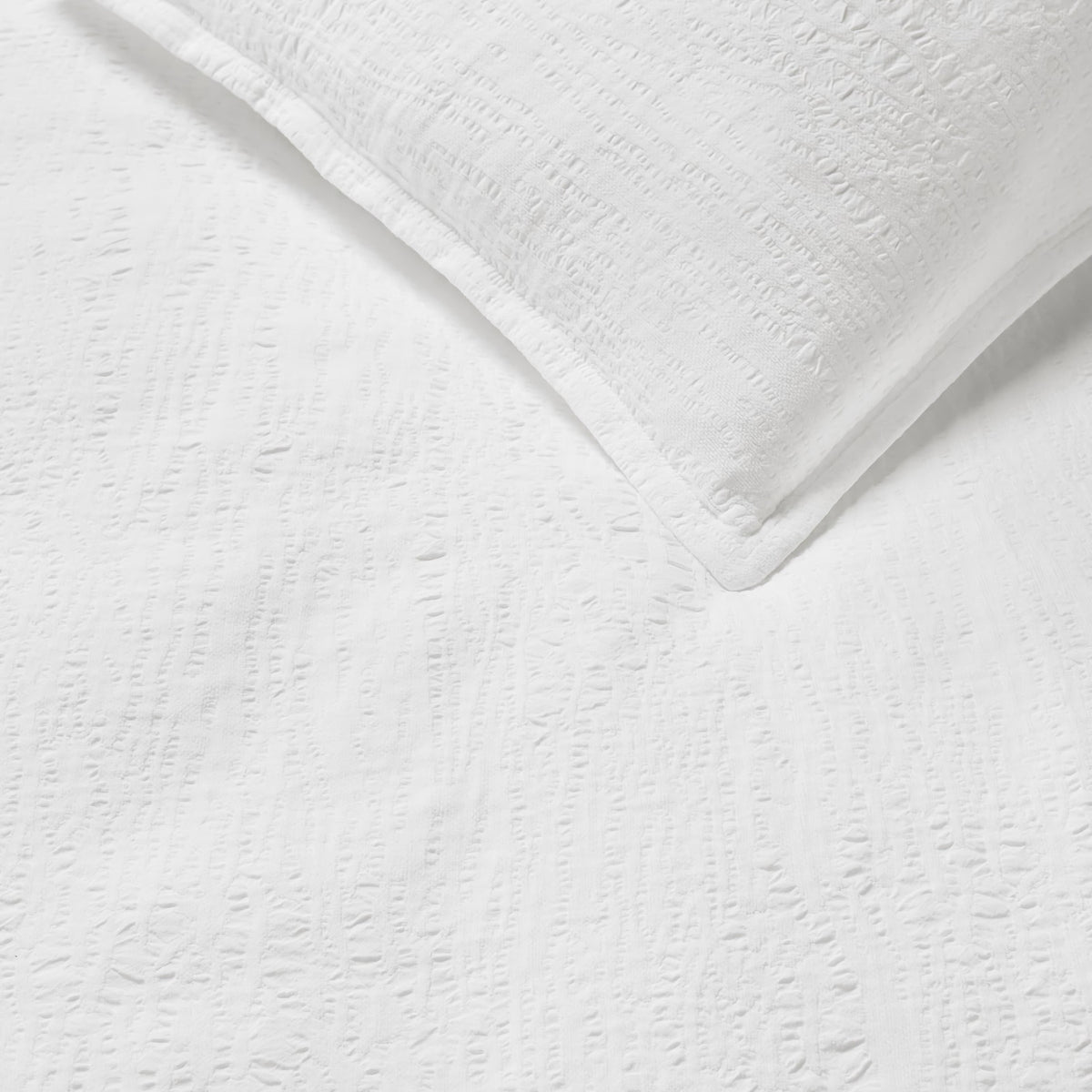 Detailed view of Sferra Sabino Coverlet and Shams in White color