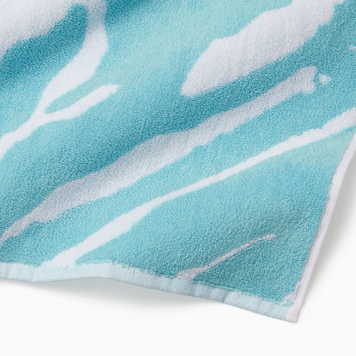 Corner Detail of Sferra Sampieri Beach Towels in Clearwater color