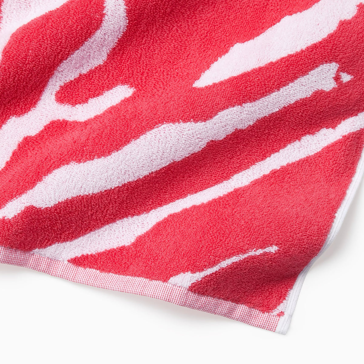 Corner Detail of Sferra Sampieri Beach Towels in Coral color