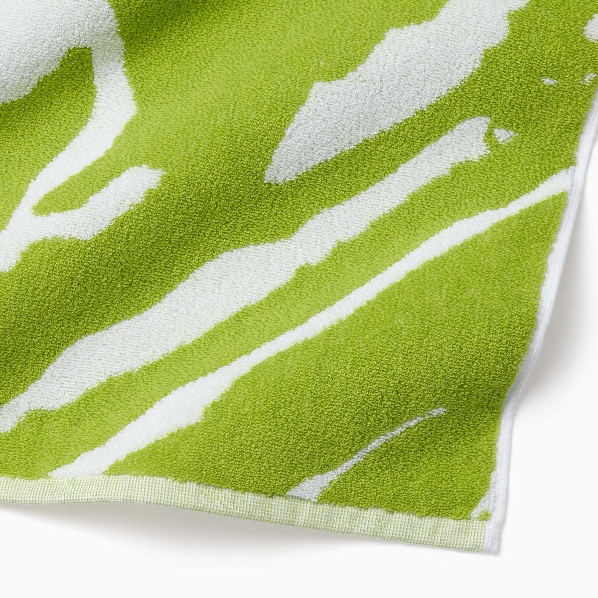 Corner Detail of Sferra Sampieri Beach Towels in Kiwi color