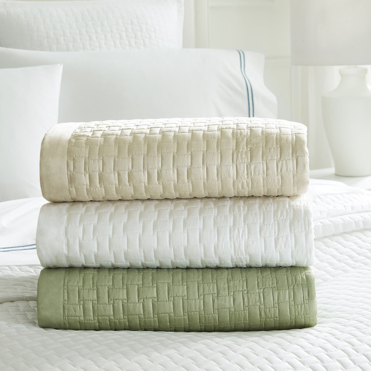 Stack of Quilted Coverlets Sferra Sampietrini in Different Colors