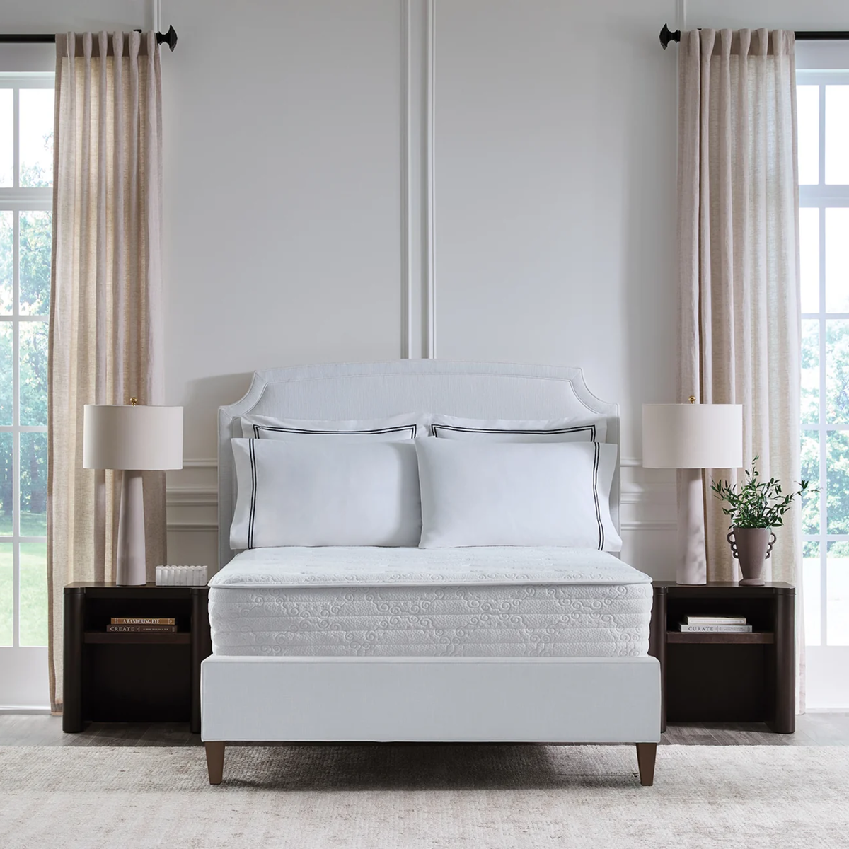 A Sferra Sognofacile Mattress in a Box sits between nightstands in a bright, airy room.