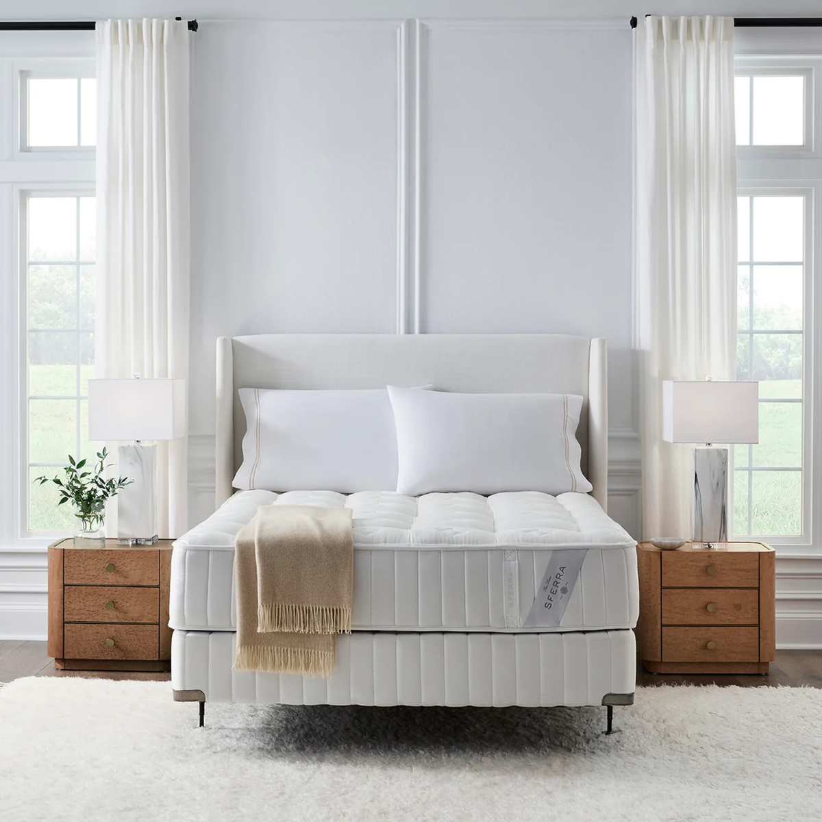A Sferra Sonno Notte CV Luxury Firm Mattress with a Pocketed Coil Innerspring, in a bright, inviting bedroom.