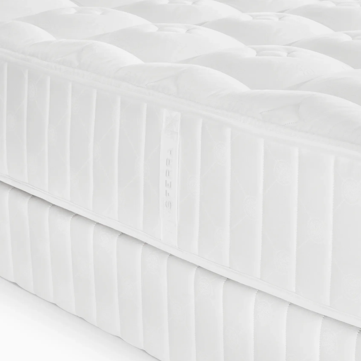 Close-up of a Sferra Sonno Notte CV Luxury Firm Mattress with quilted cover, showcasing pocketed coil innerspring and subtle texture details.