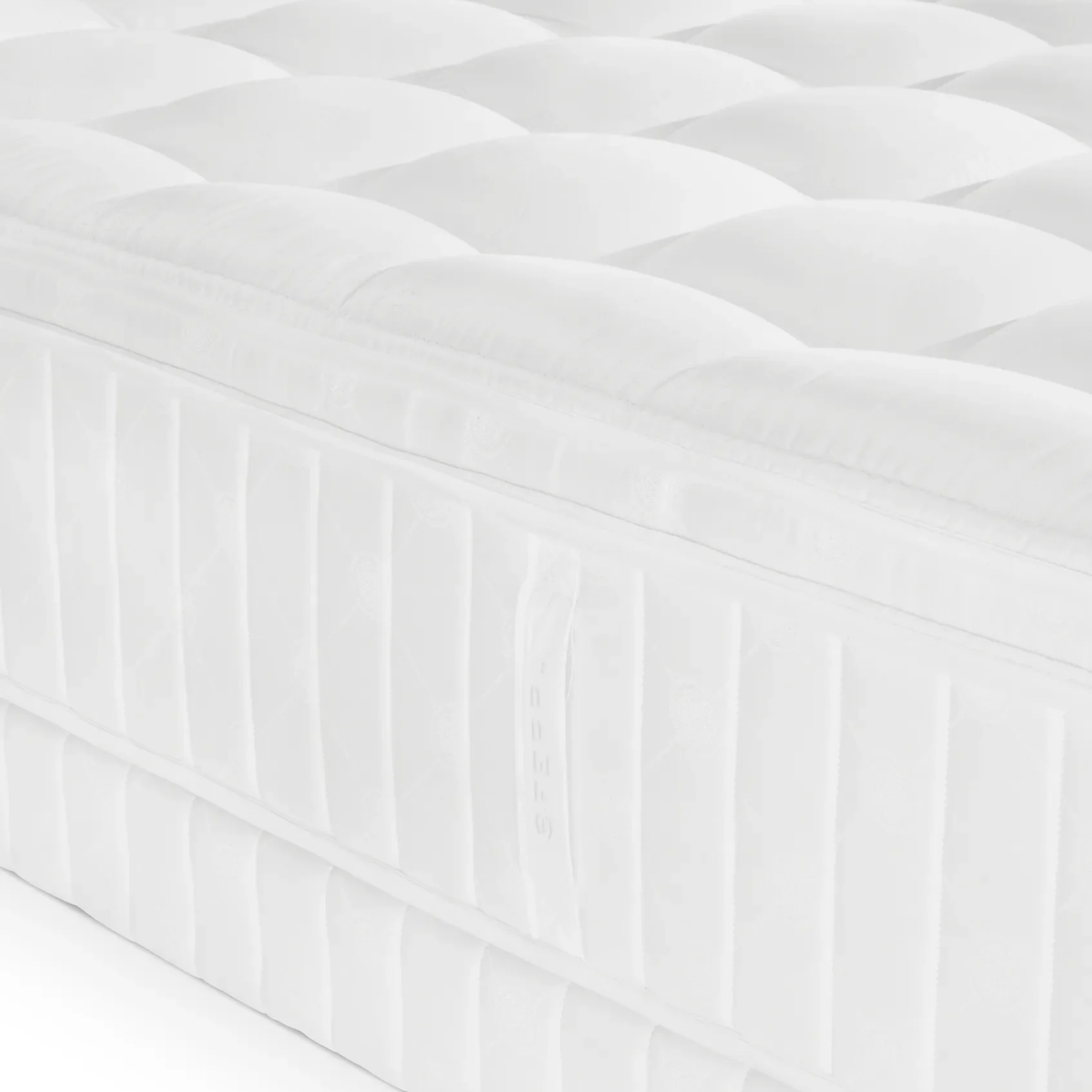 Close-up of a white, quilted innerspring Sferra Sonno Notte CV Pillowtop Mattress with a side handle and vertical stitching detail.