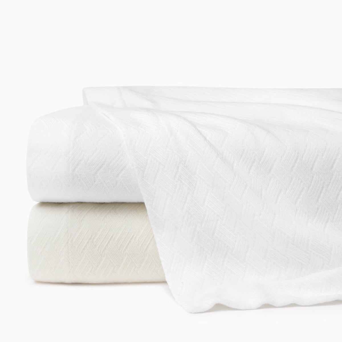 Stack of White and Ivory Sferra Spinato Blankets