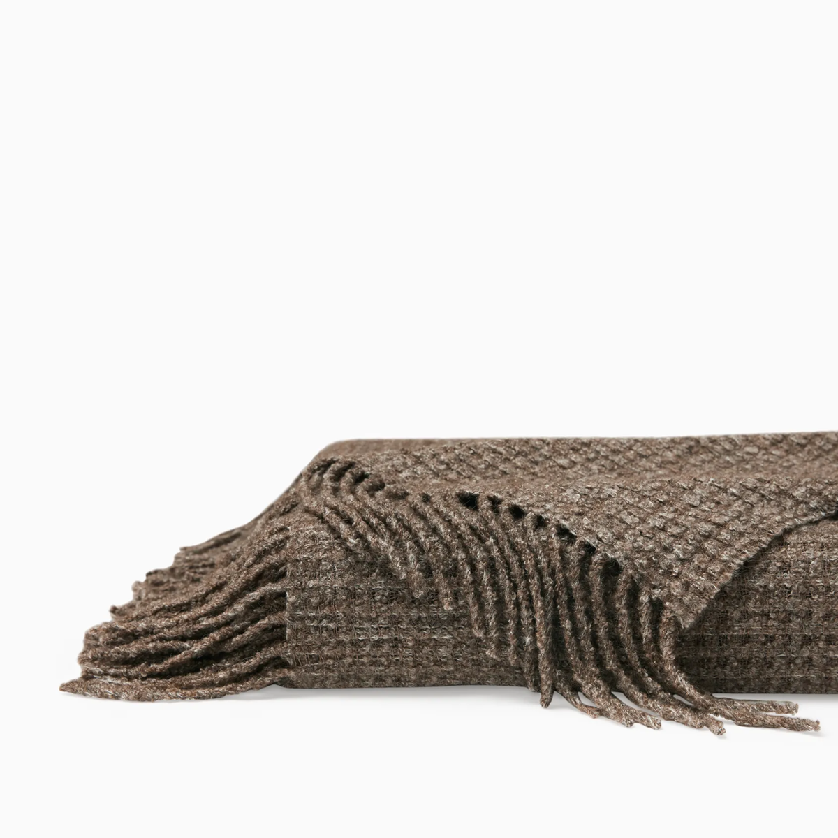 Folded Sferra Terranova Throw in Khaki color showing its twisted fringes