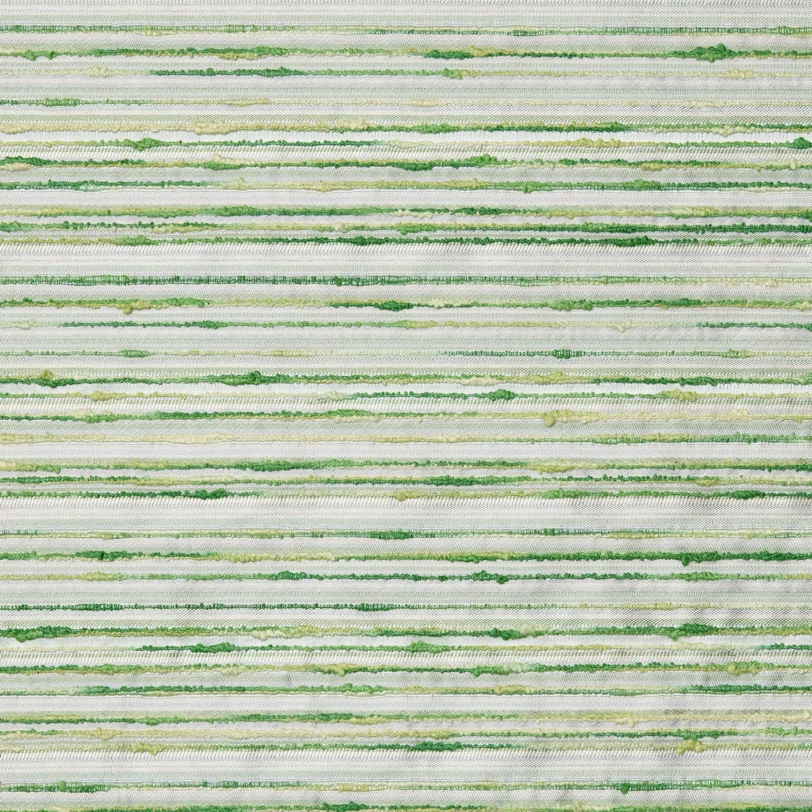 A white chaise lounge with an Italian woven pillow, next to a table with flowers, on a woven rug.