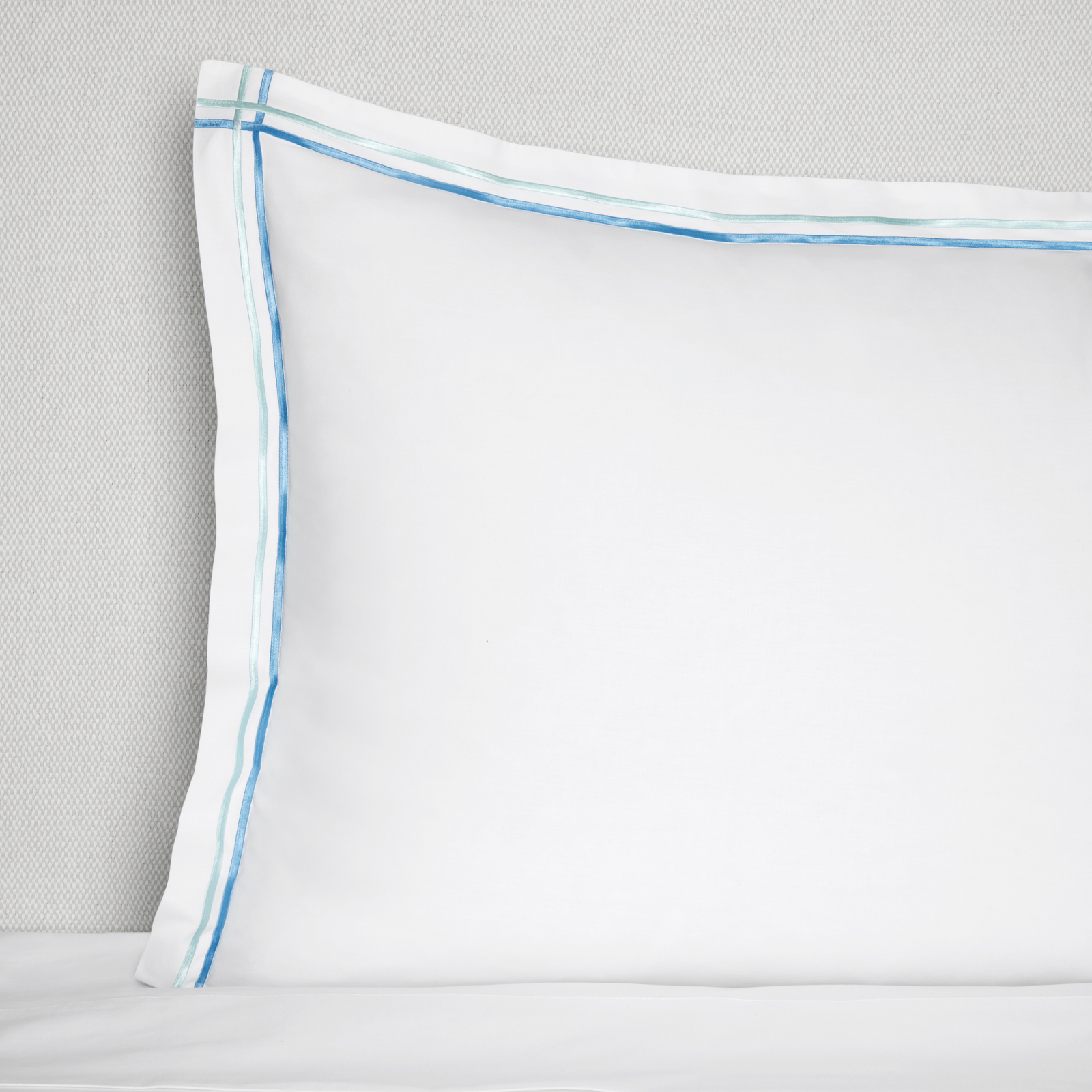 Full Lifestyle Image of Sferra Tratto Bedding with Swatch of White/Clearwater