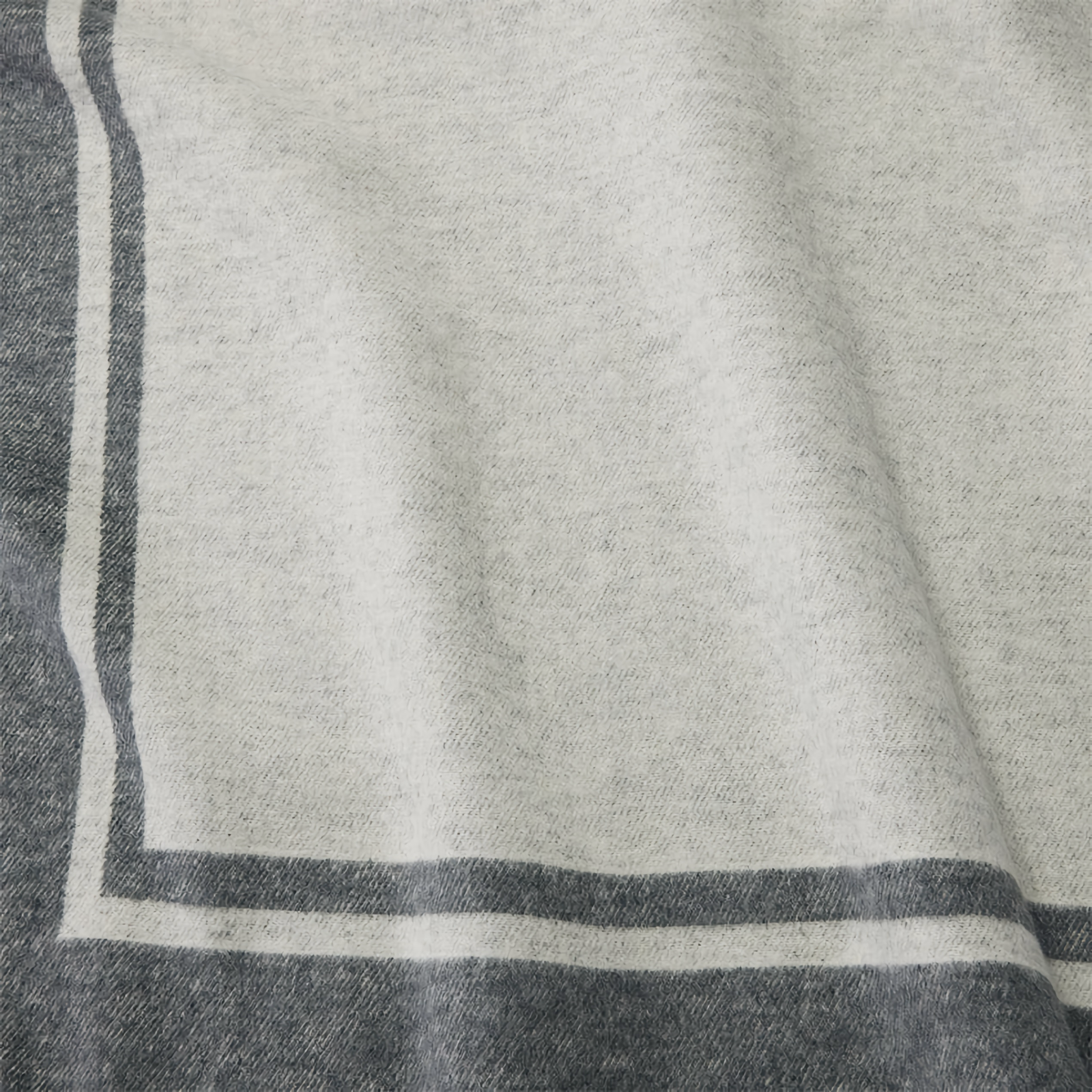 Folded Sferra Viletta Throw Blanket in Oat and Charcoal Color