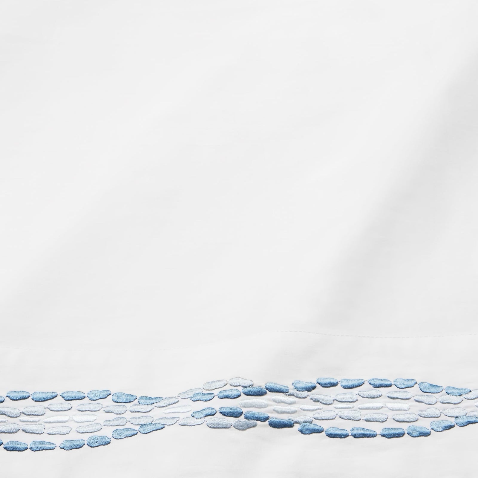 Bed with Sferra X Scalamandre Cobblestones Embroidered Bedding in White/Sea color