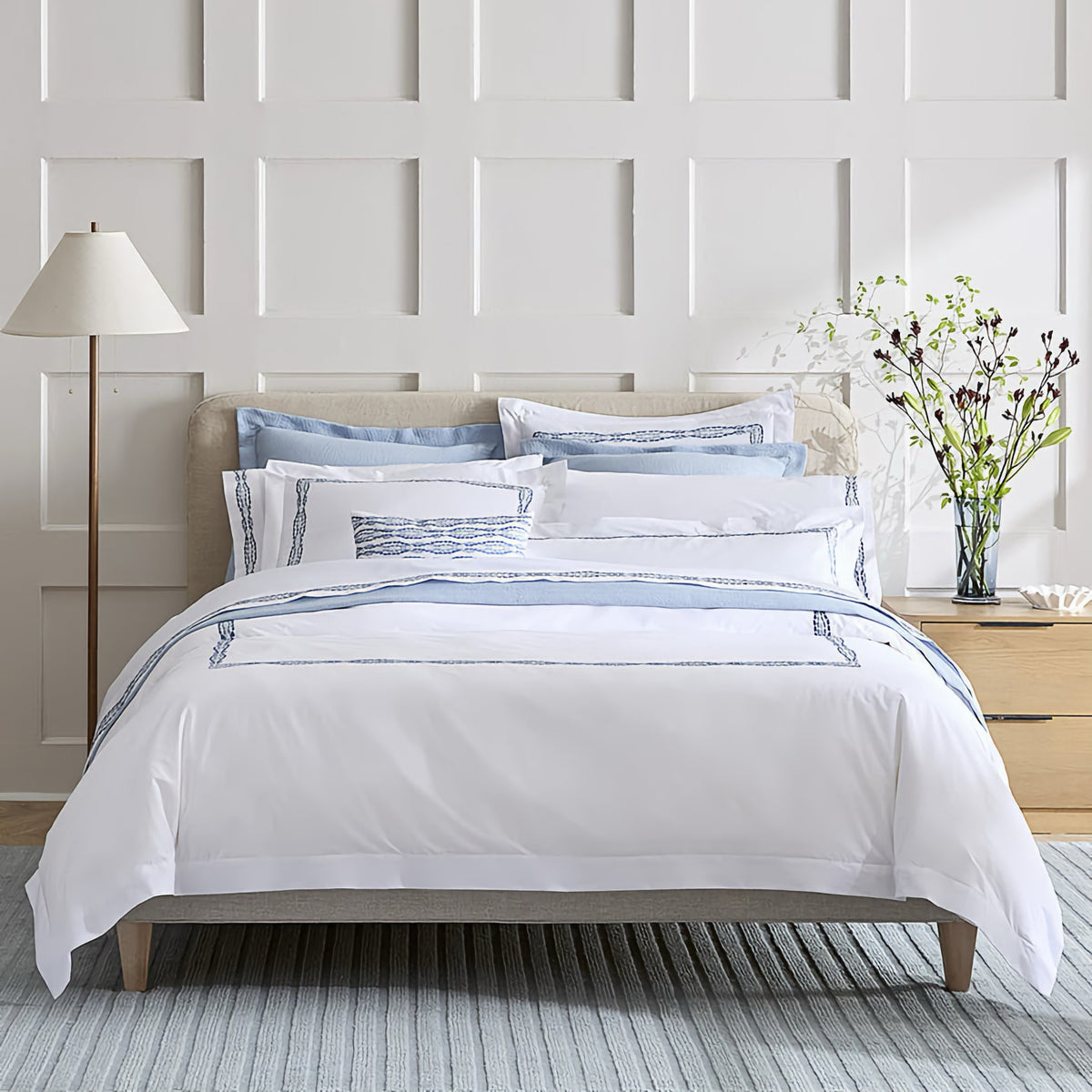 Bed with Sferra X Scalamandre Cobblestones Embroidered Bedding in White/Sea color