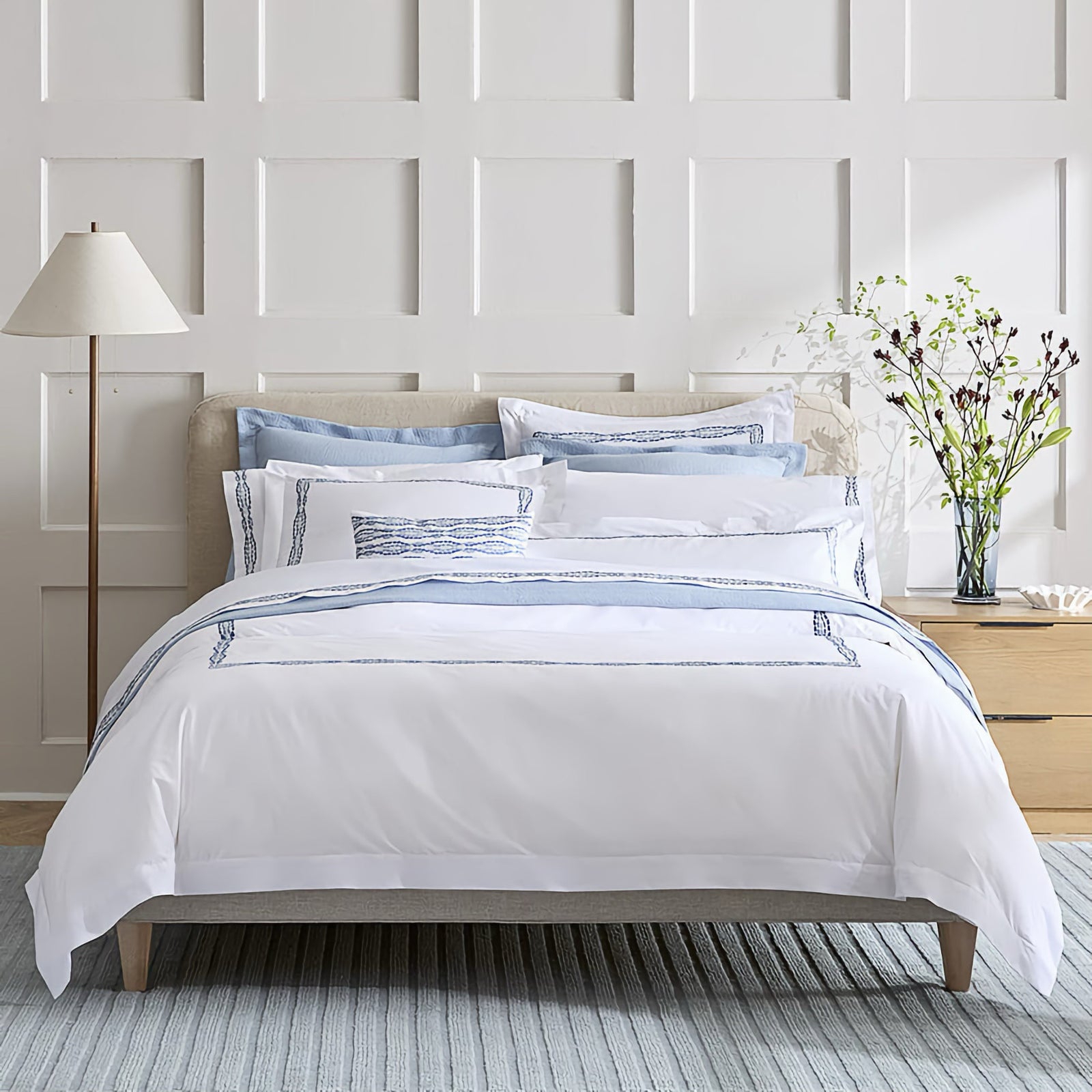 Bed with Sferra X Scalamandre Cobblestones Embroidered Bedding in White/Sea color