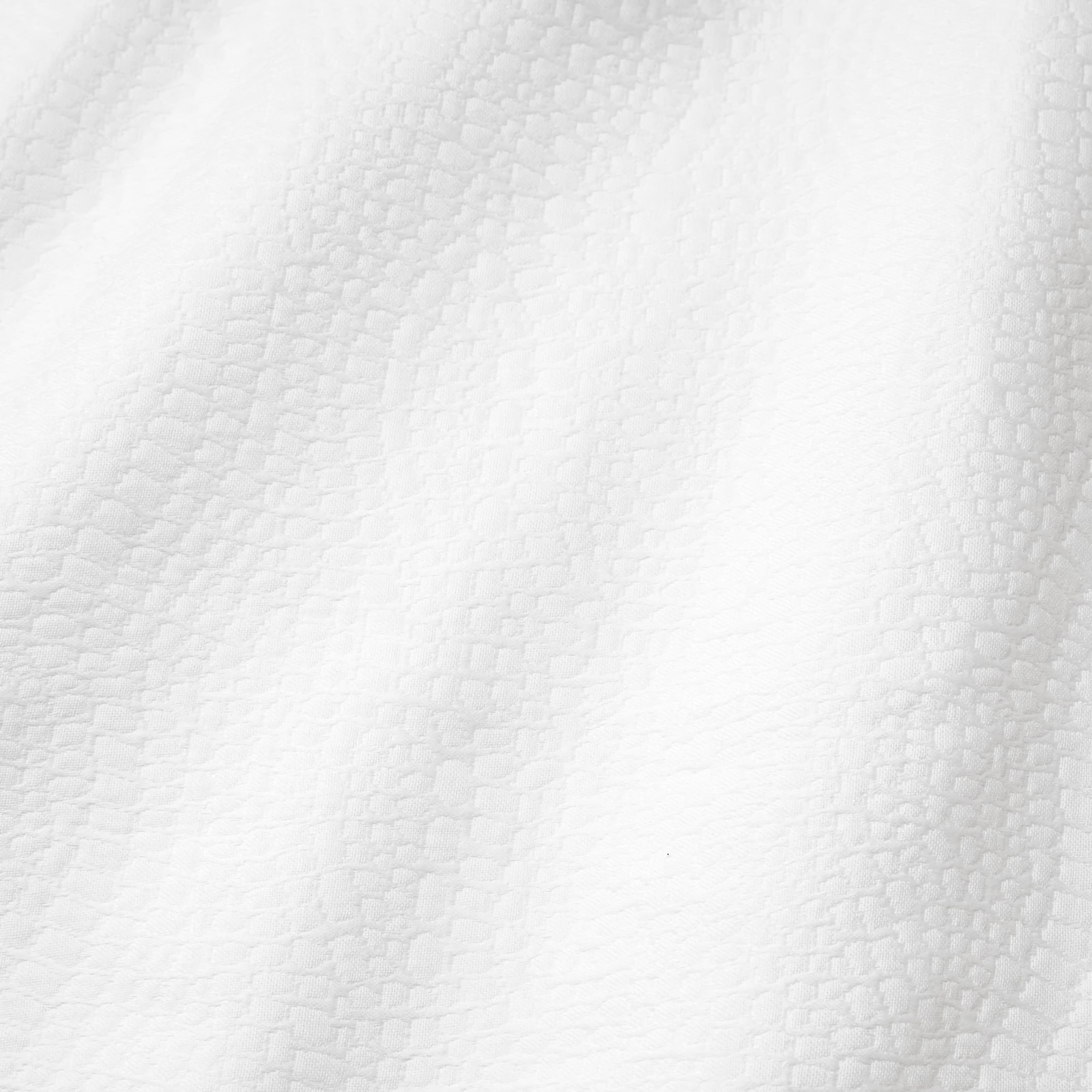 Closeup of Sferra X Scalamandre Cobblestones Coverlet and Shams in White