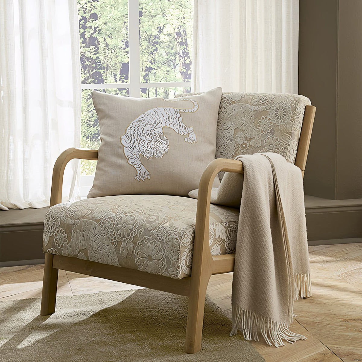 Sferra X Scalamandre Siberian Tiger Decorative Pillow in Natural on a chair