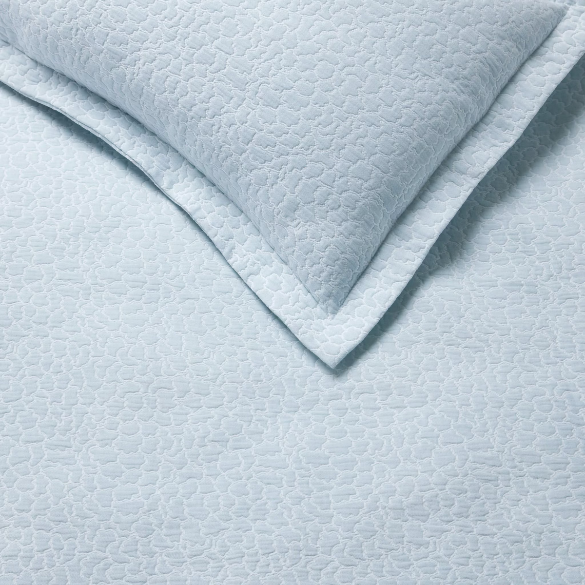 Detail View of White and Poolside color Sferra x Scalamandre Aurelia Coverlet and Sham