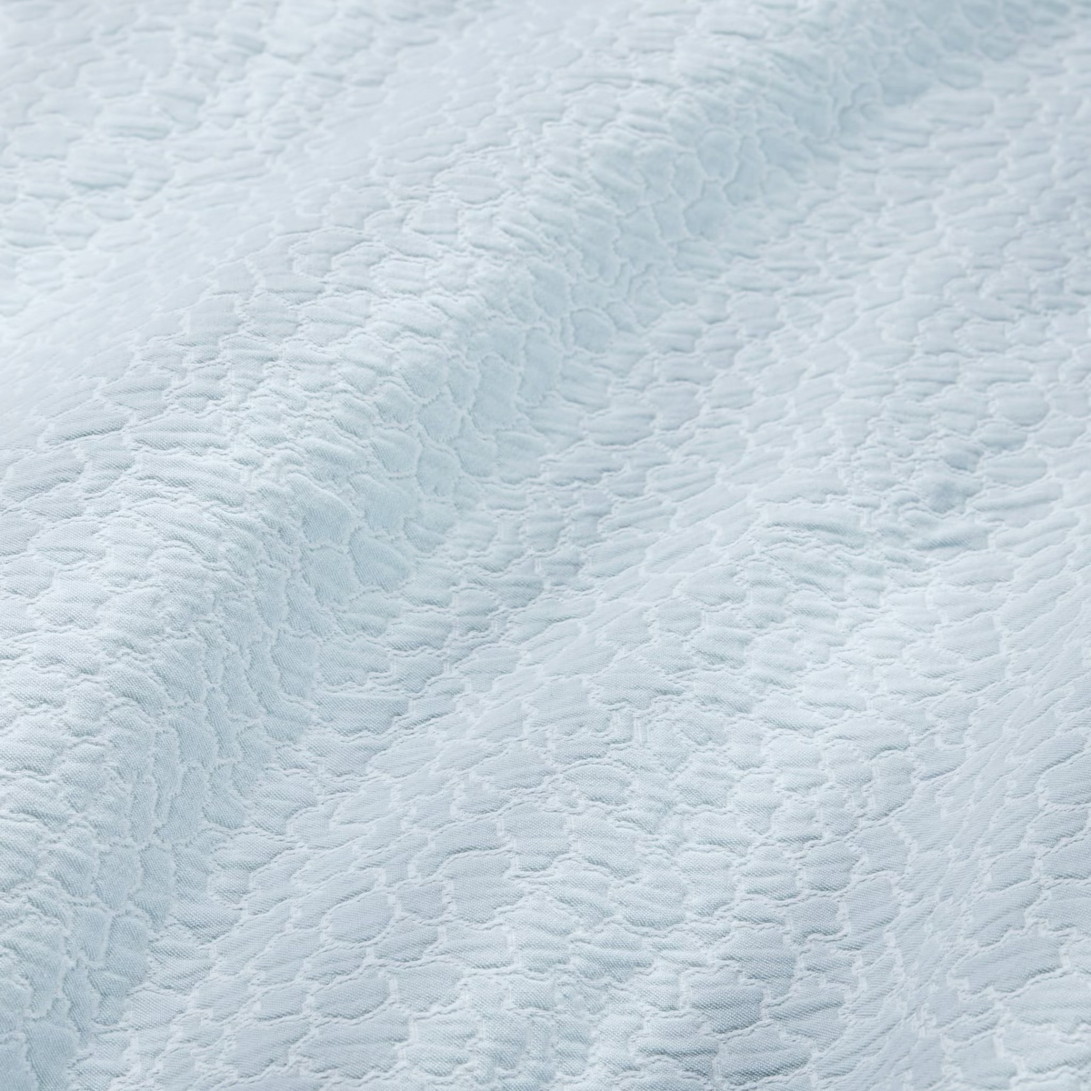 Fabric Closeup of White and Poolside color Sferra x Scalamandre Aurelia Coverlet and Sham