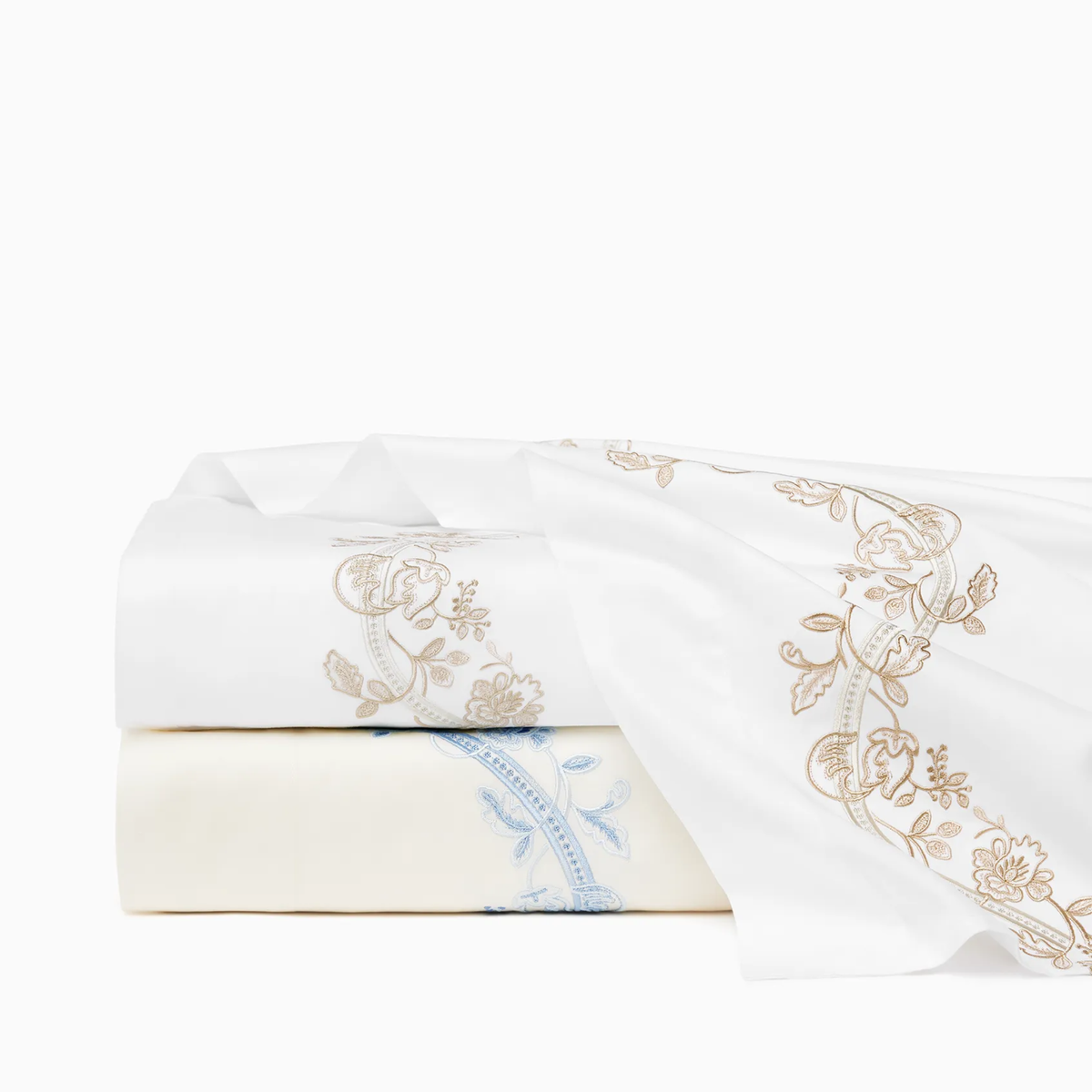 Stack of Sferra x Scalamandre Isabella Sheets in White/Sand and Ivory/Sea Embroidery
