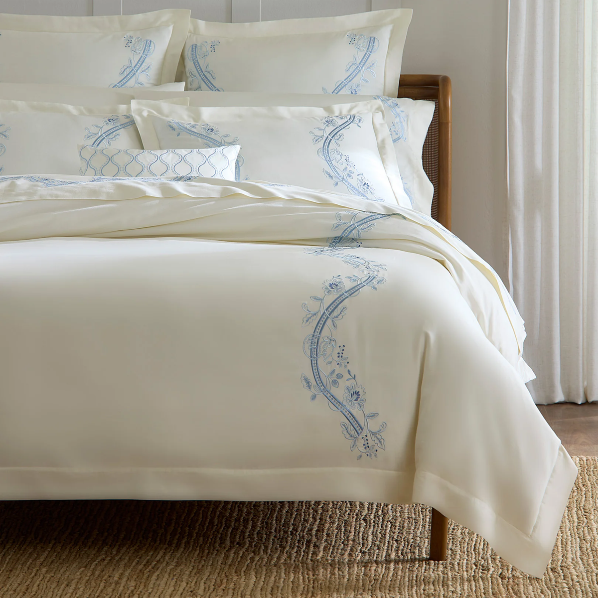 Closeup of Bed with Sferra x Scalamandre Isabella Bedding in Ivory/Sea Embroidery