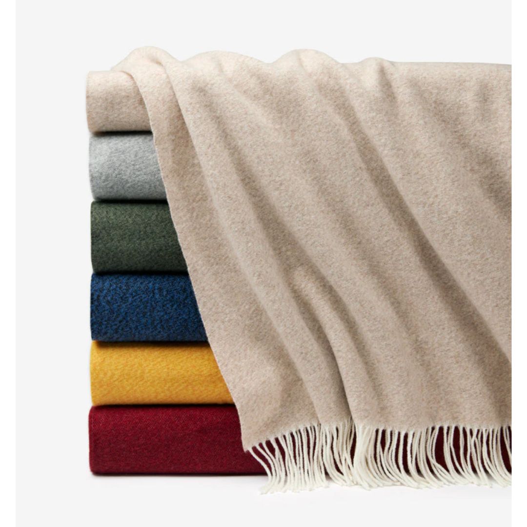Stack of Sferra Matese Throws - from top to bottom - Beige, Grey, Loden, Navy, Sunshine, Merlot