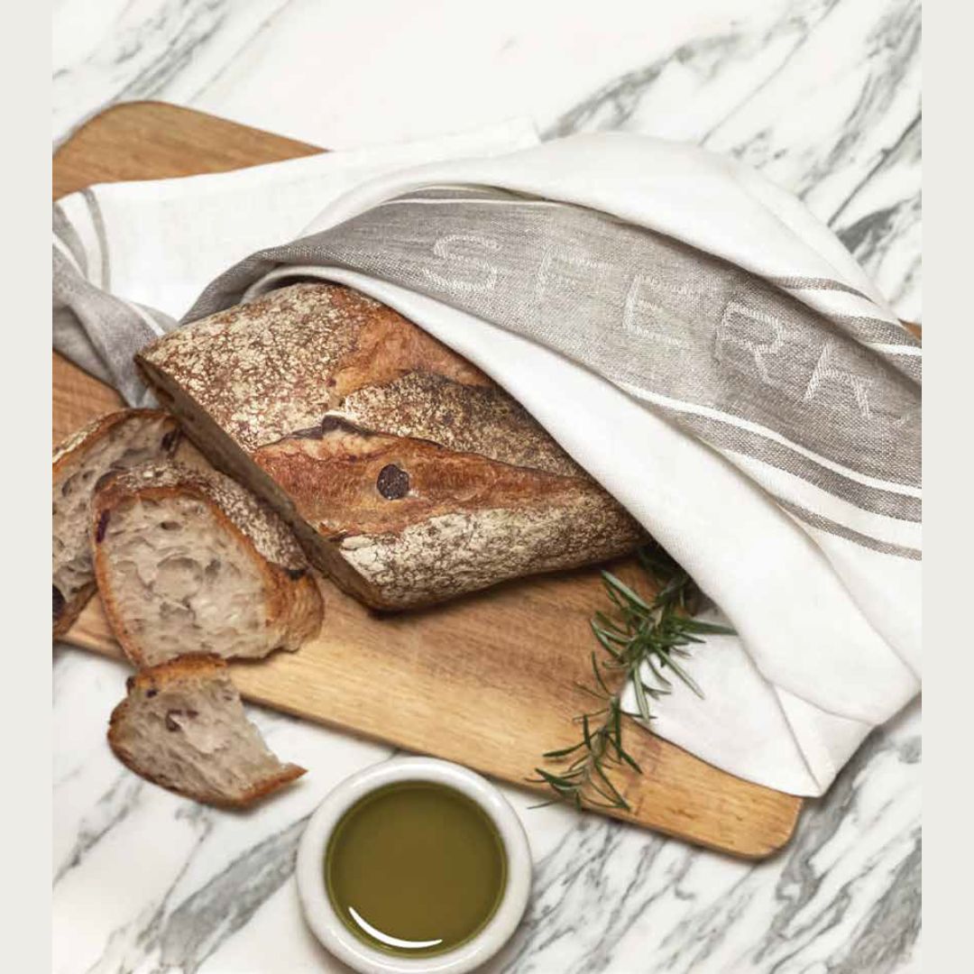 Sferra Kitchen towel wrapped around a loaf of bread