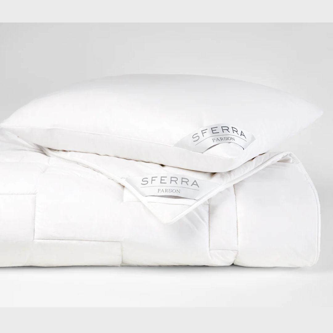 A white pillow and comforter set with Sferra Parson labels, featuring a hypoallergenic duvet, against a plain background.
