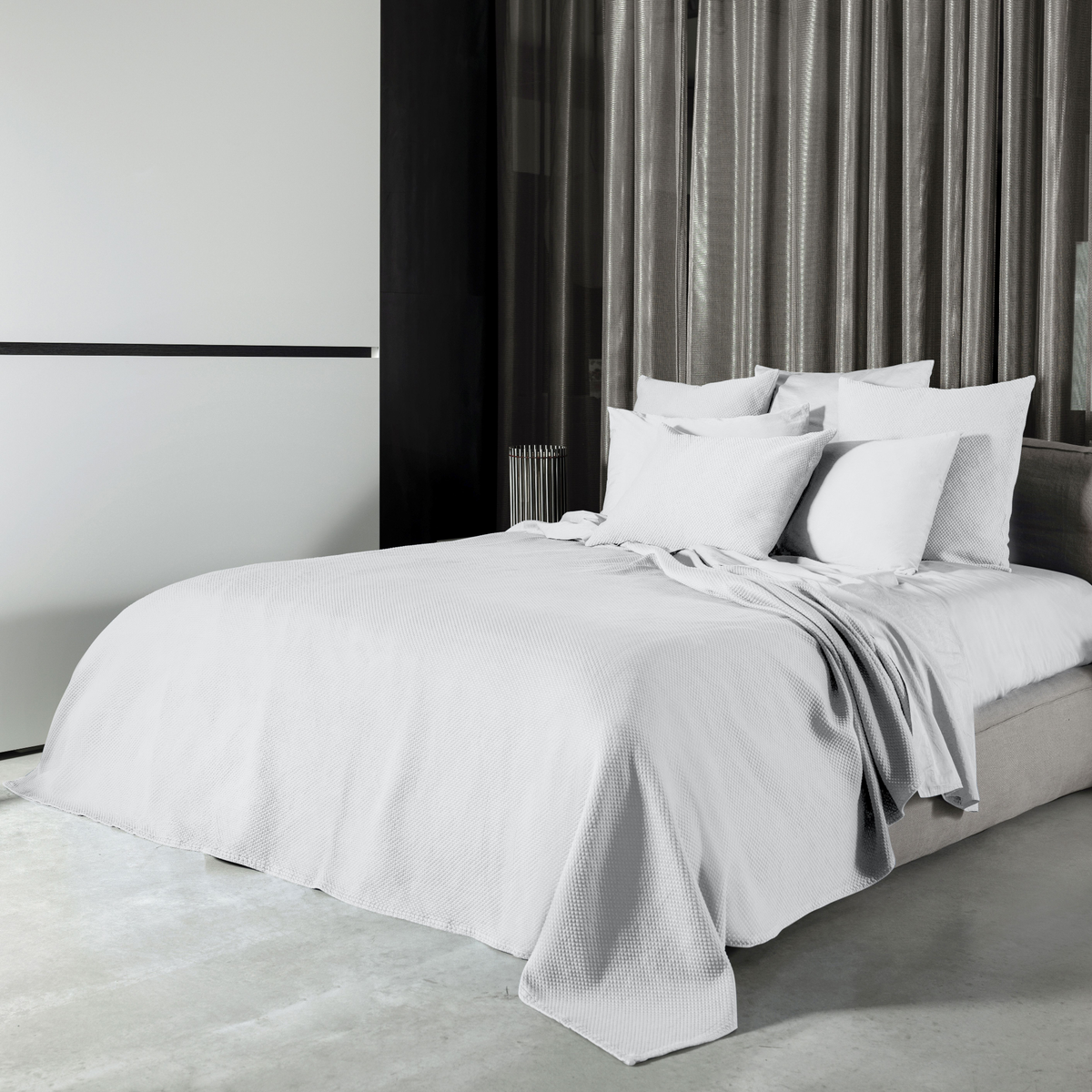 White Signoria Olivia Coverlet and Shams on a Bed in a Room