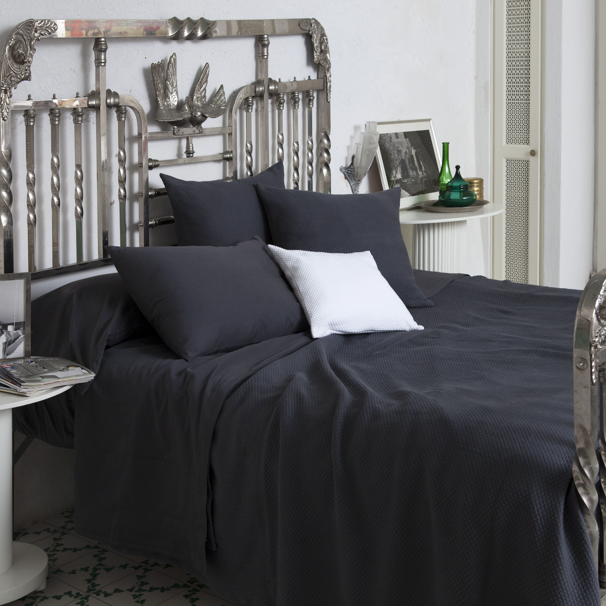 Lifestyle Image of Charcoal Signoria Olivia Coverlet and Shams on a Bed in a Room