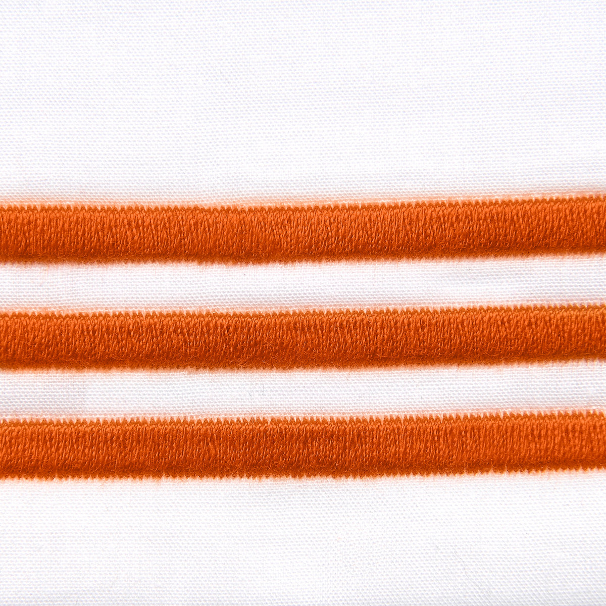 Fabric Closeup of Signoria Platinum Percale Bedding in White/Rust Color