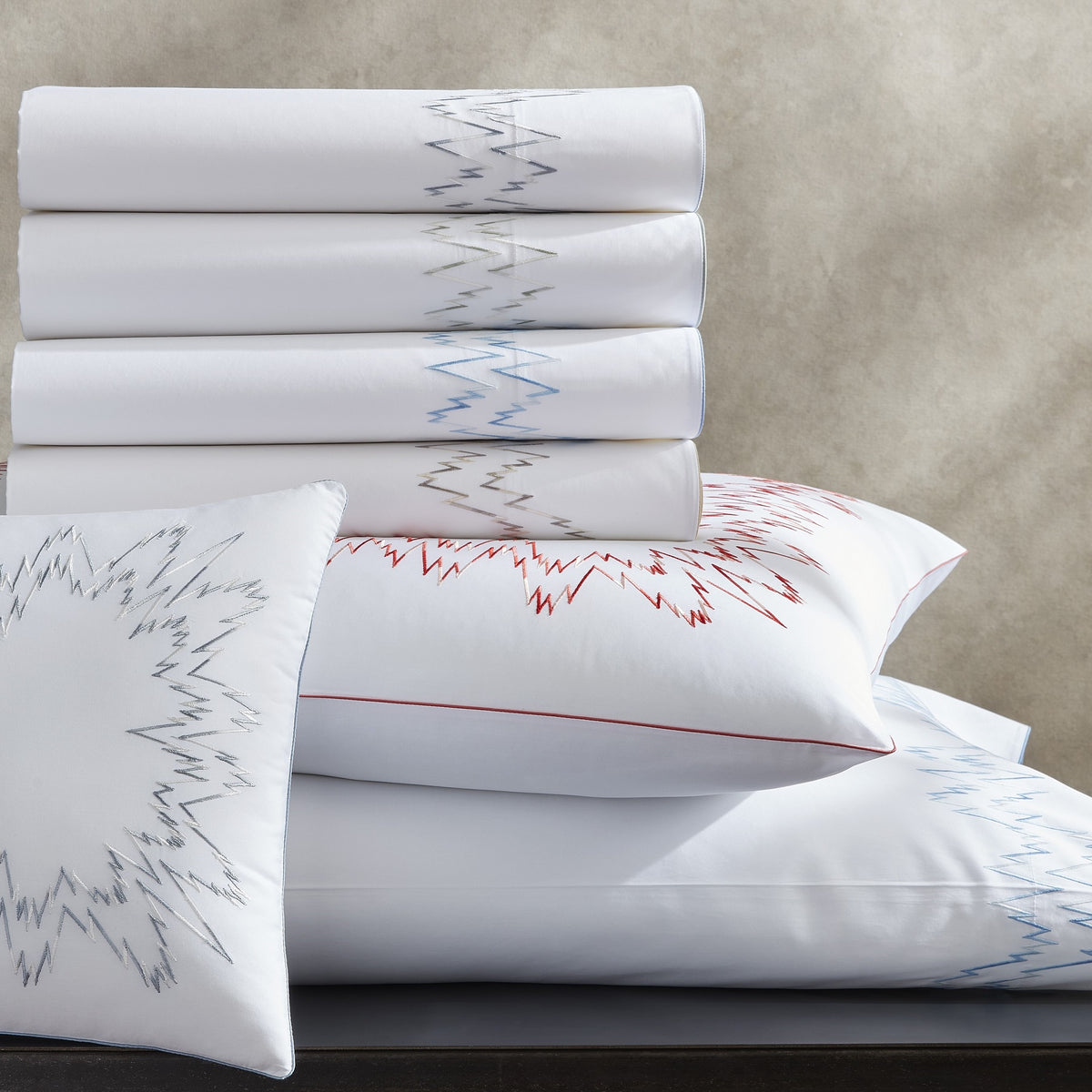 Stack of Matouk Aries Bedding in Different Colors
