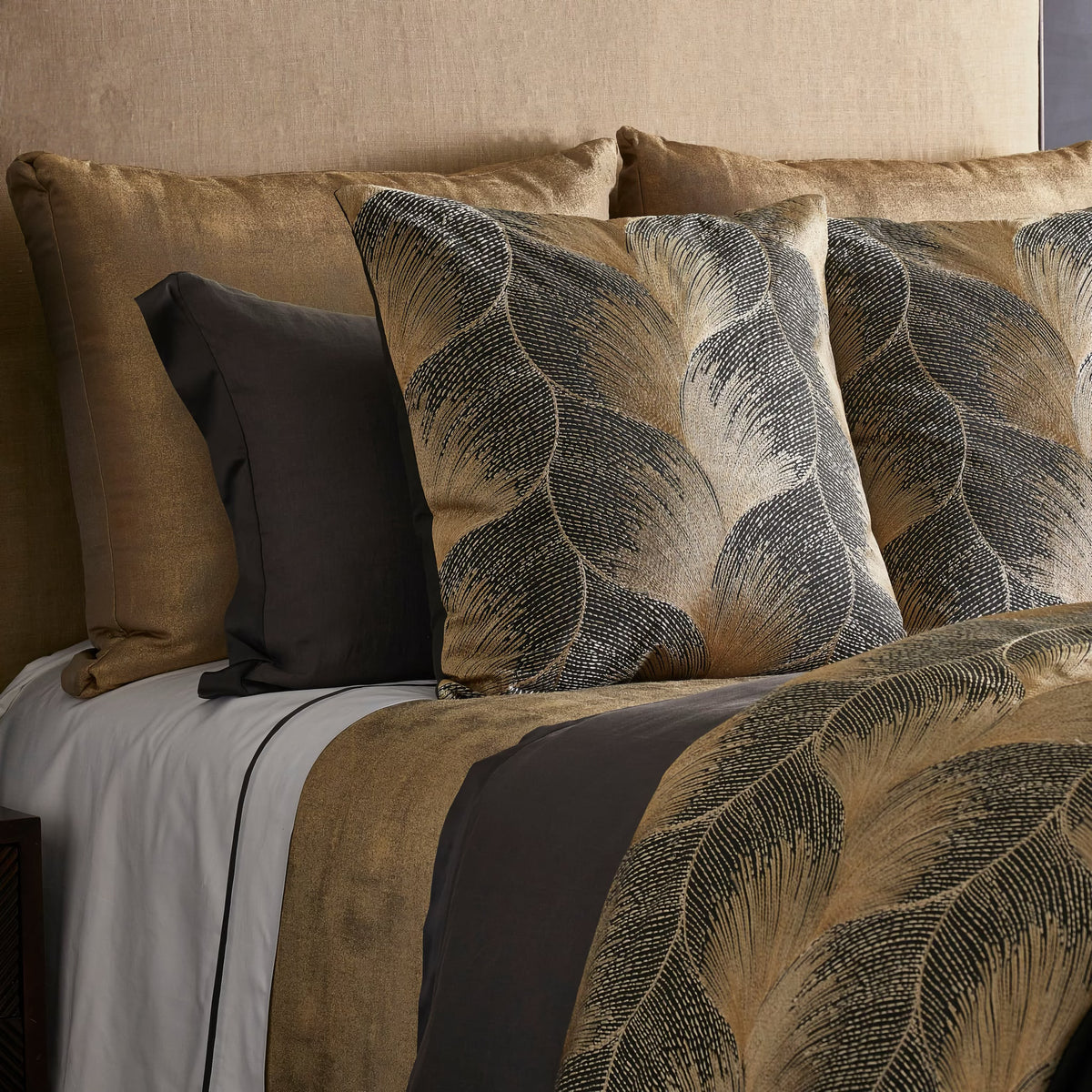 Closeup of The Met x Ann Gish Fan Duvet Cover and Decorative Pillow in Umber and Gold
