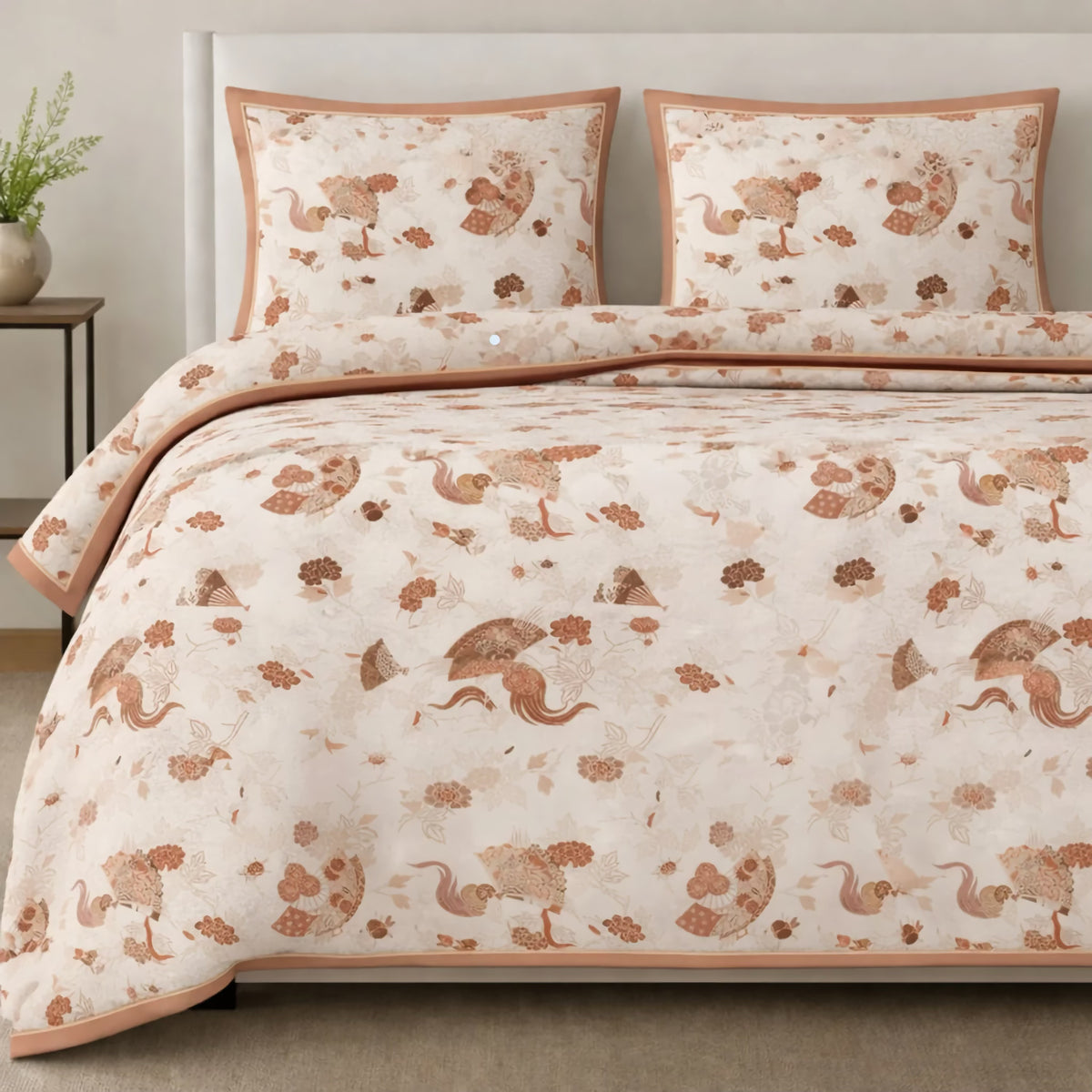 A bed in Peach-colored The Met x Ann Gish Sensu Comforter Set with art-inspired bedding and pillows