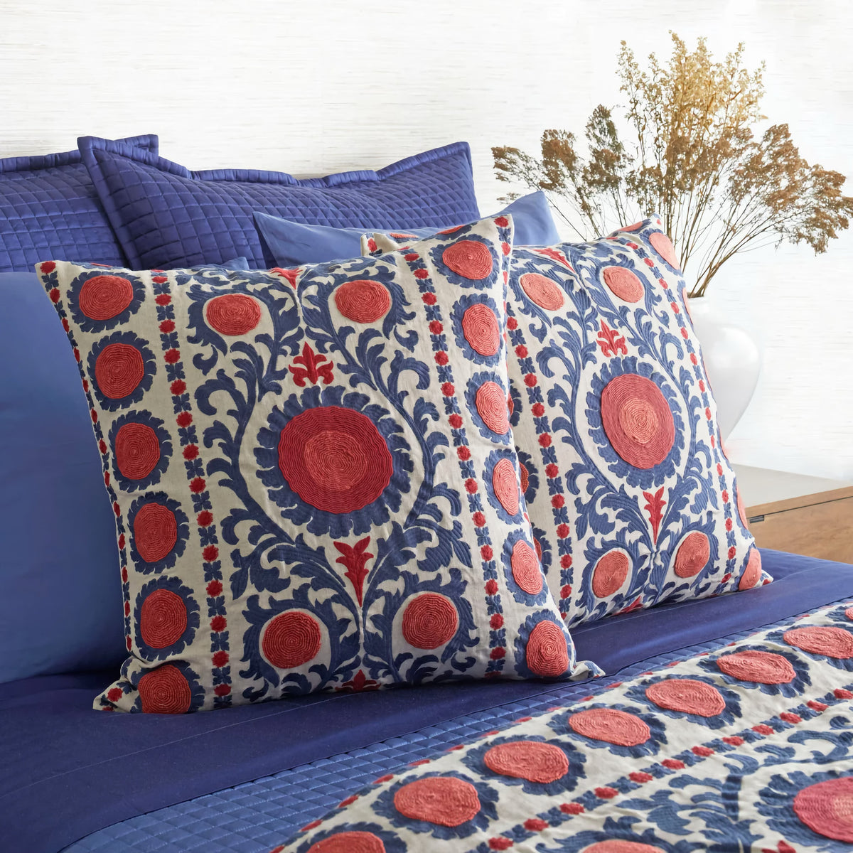 Closeup of The Met x Ann Gish Suzani Throw and Decorative Pillow in Indigo