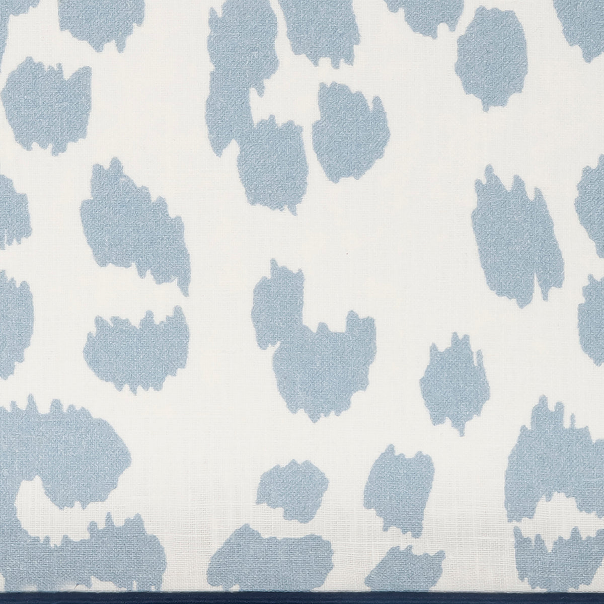 Patterned fabric with blue abstract shapes on a white background