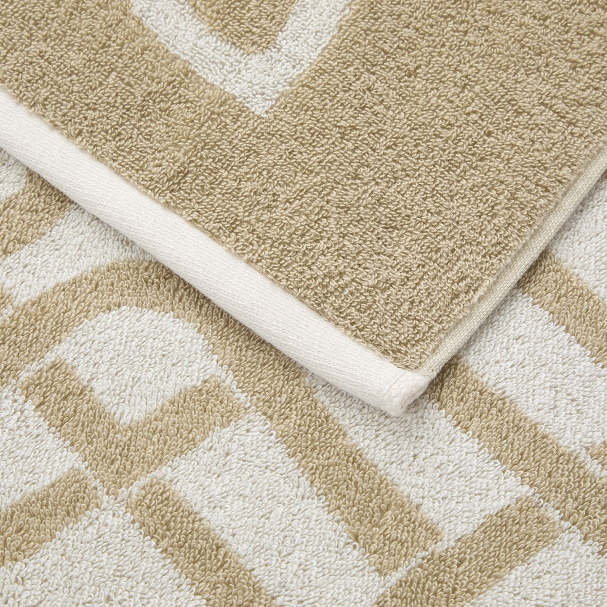 Yves Delorme Apollon Bath Collection in Dune color, highlighting texture and edging details.