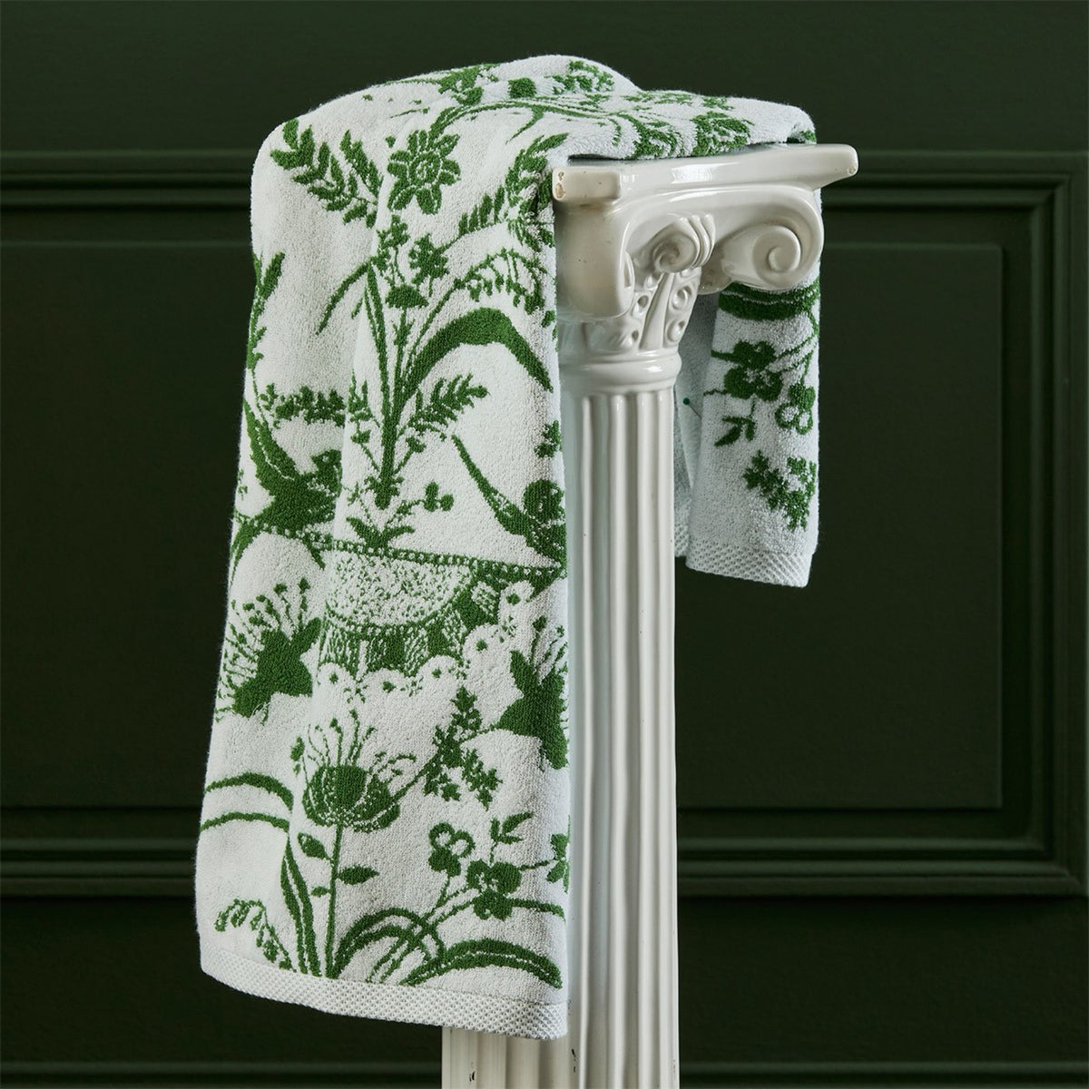 Yves Delorme Botanic Bath Towel hanging on a column