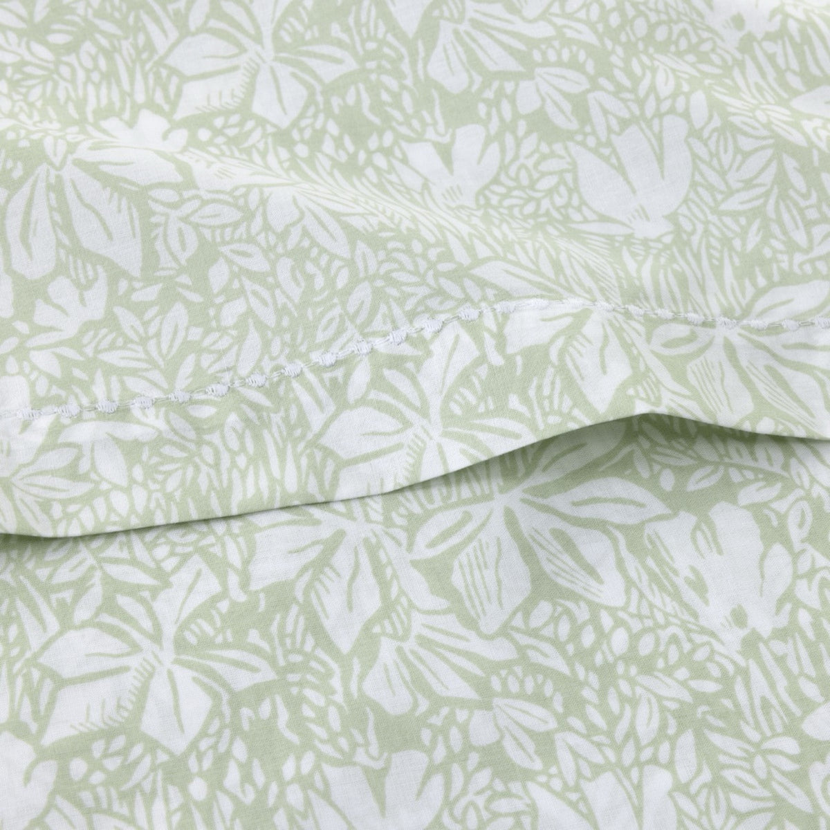 Close-up of Yves Delorme Capri Bedding cotton batiste in Amande pattern and visible seam stitching