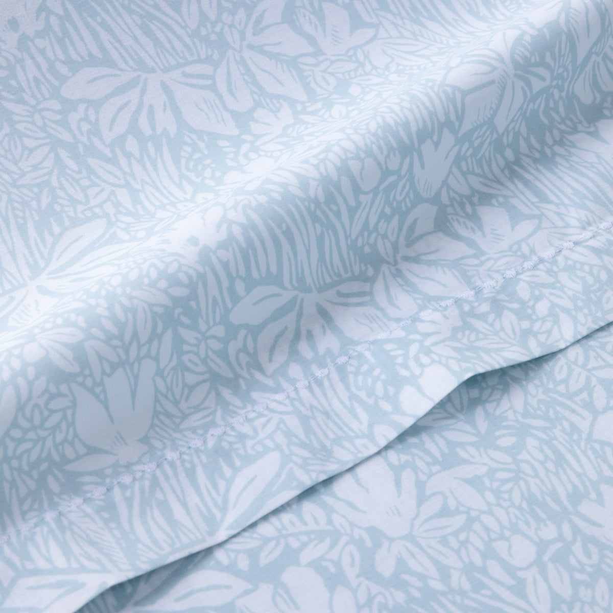 Close-up of Yves Delorme Capri Bedding cotton batiste in Aqua pattern and visible seam stitching