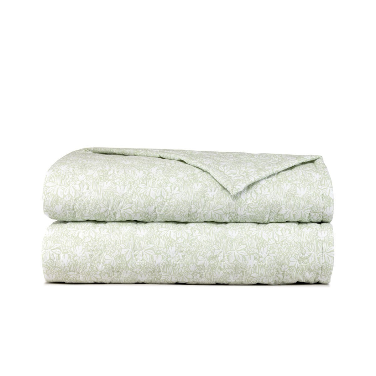 A folded light green comforter from the Capri Collection, featuring a white floral pattern, on a plain white background.