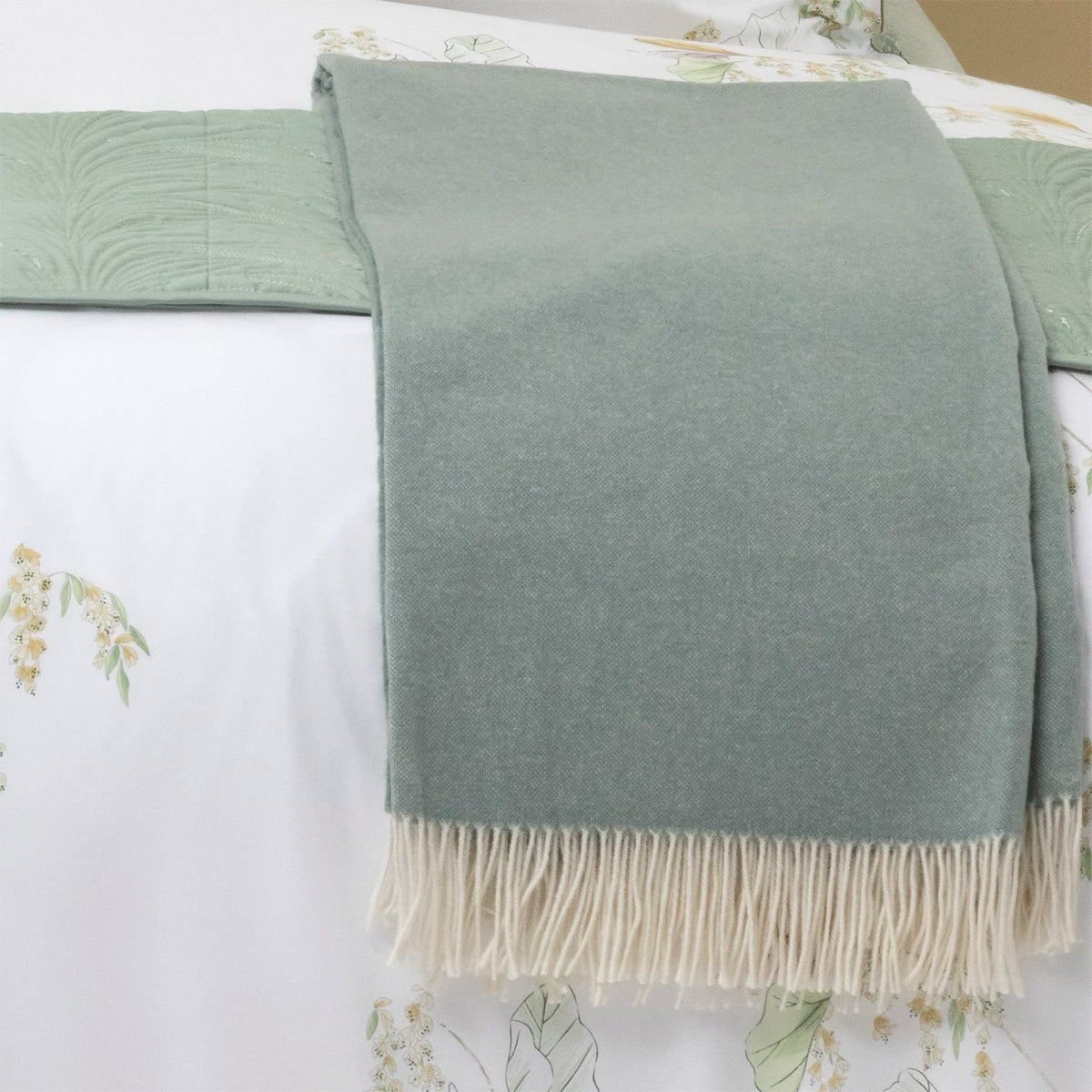 Yves Delorme Club Throw in Verones Color on a bed