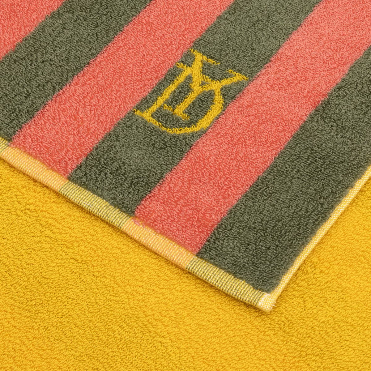 Closeup of Yves Delorme Corail Beach Towel in Goyave color