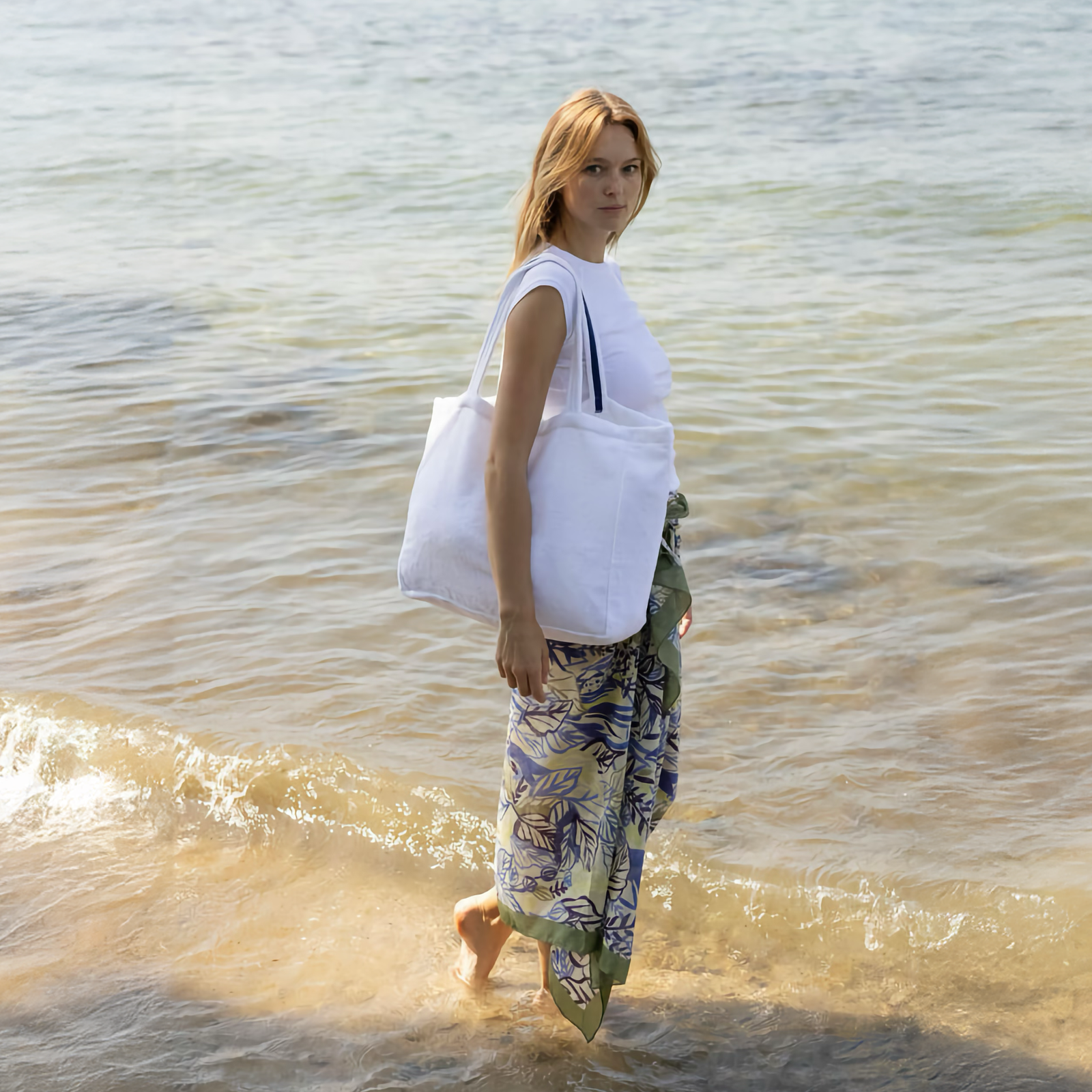 Woman with Yves Delorme Croisiere Beach Bag in Blanc