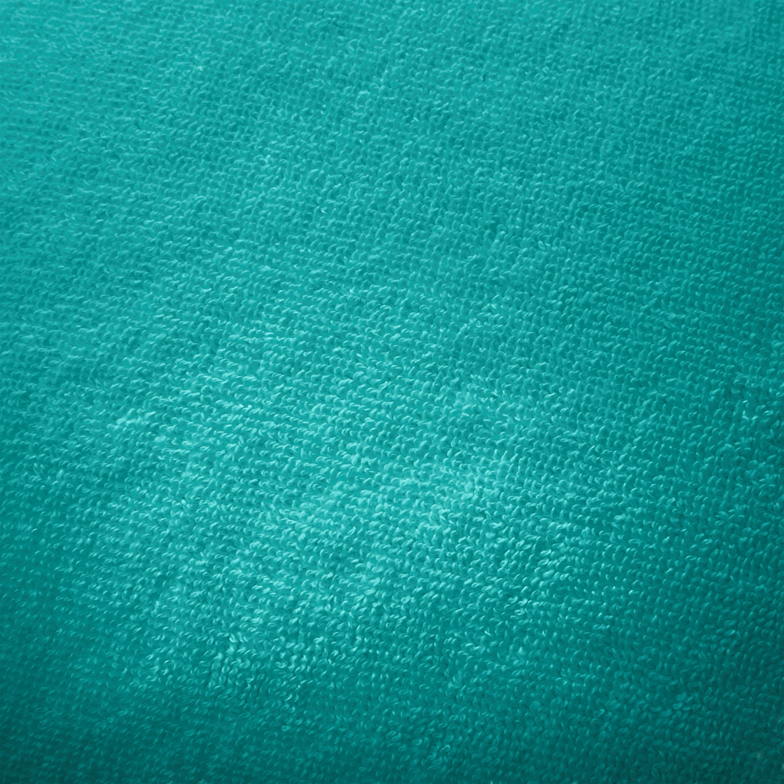 Yves Delorme Croisiere Beach Pillow in Caraibe on floor 