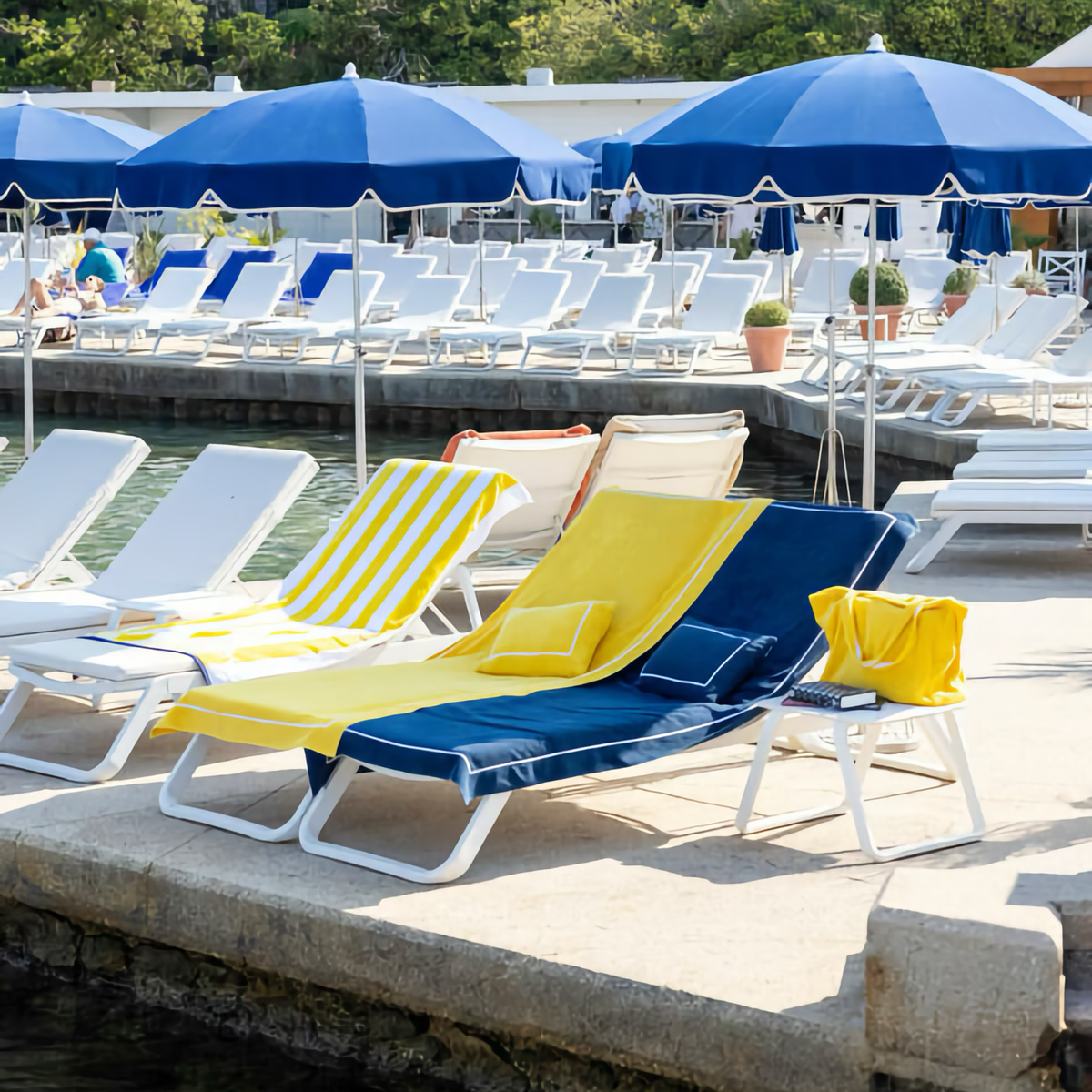 Yves Delorme Croisiere Beach Pillow in Riiera and Marine on benches