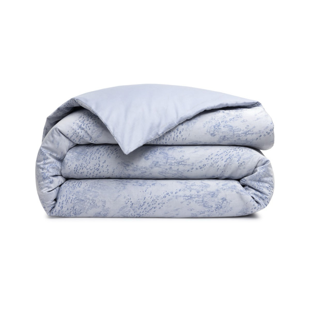 A folded Duvet Cover of Yves Delorme Ecumes Bedding on a white background