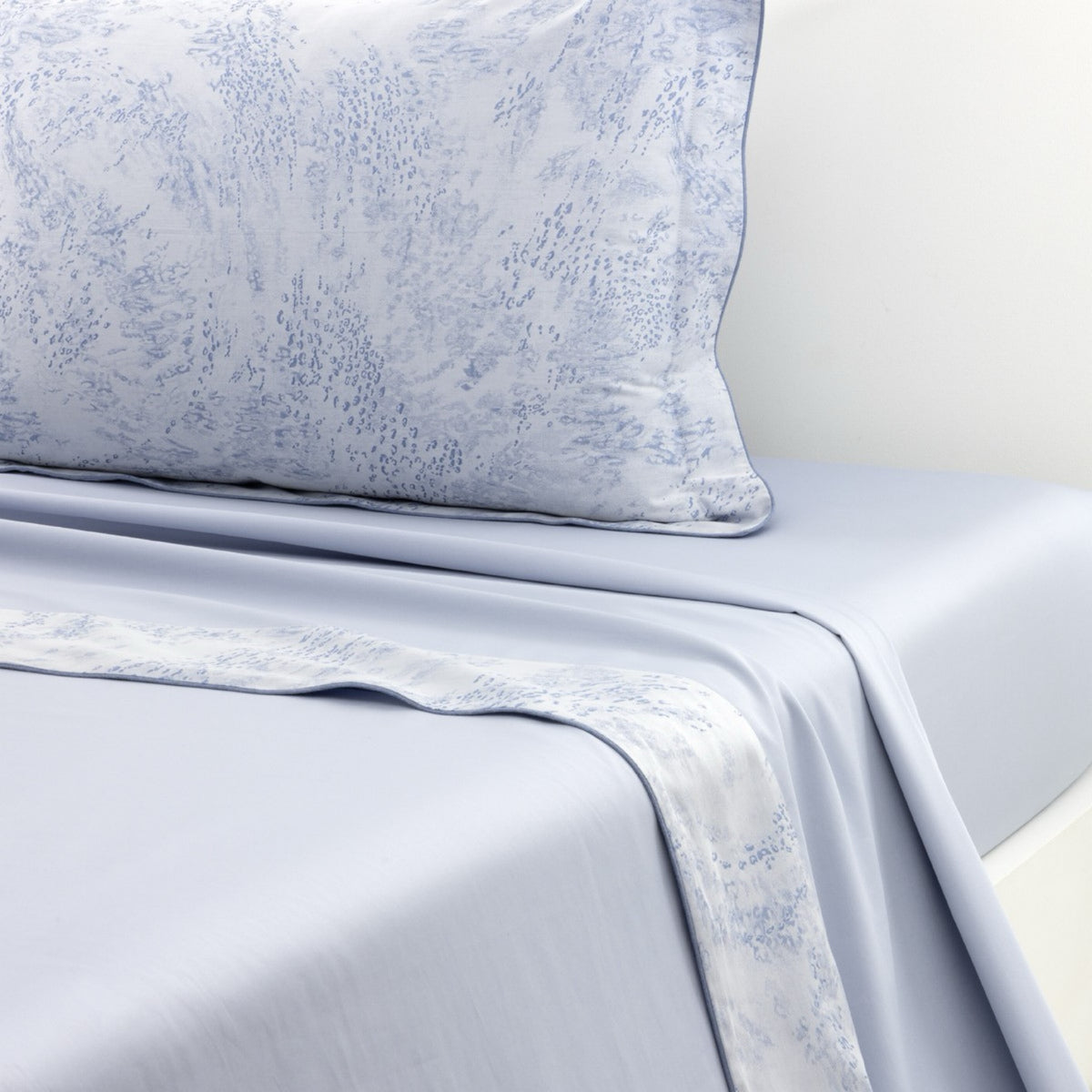 Flat Sheet of Yves Delorme Ecumes Bedding on a white background