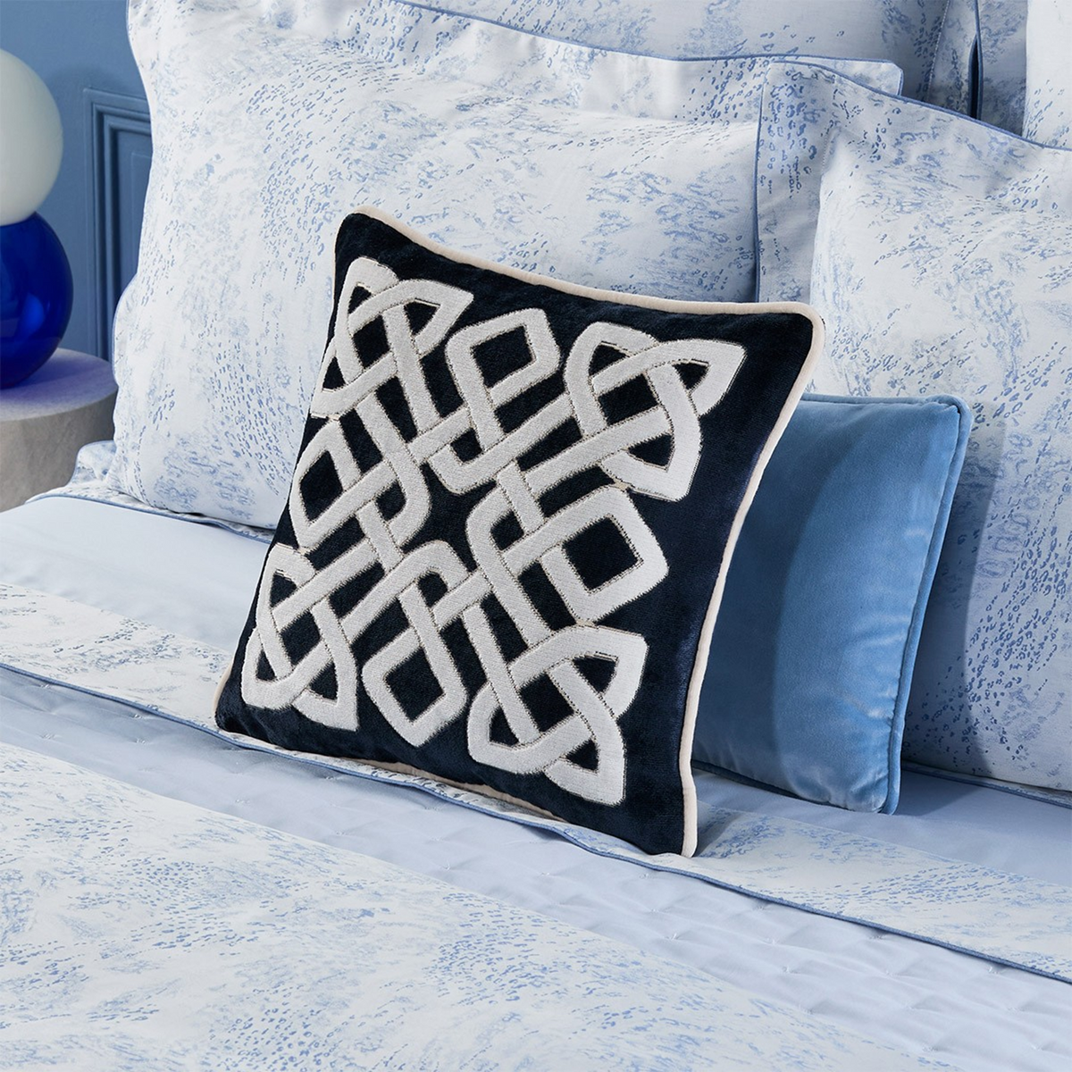 Decorative Pillow of Yves Delorme Entrelac Marine Bedding Collection on a Blue Bedding